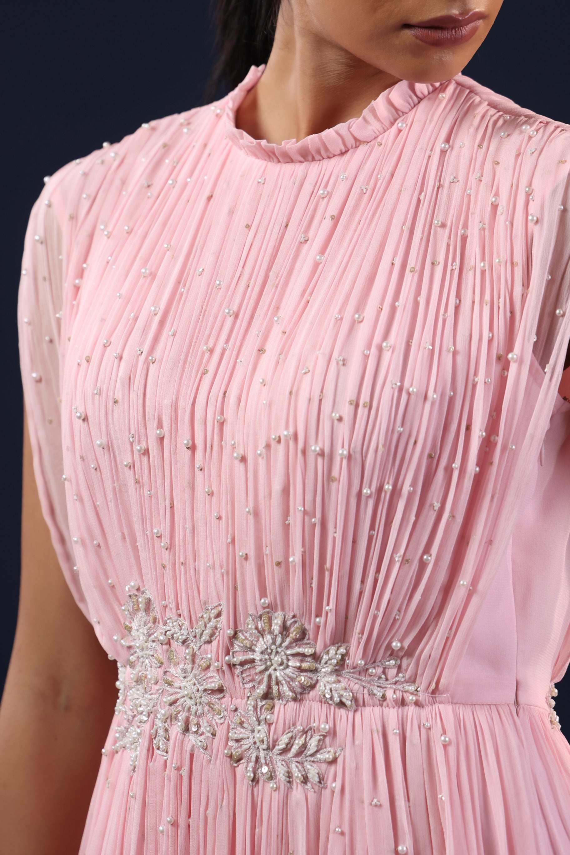 ELEGANT PINK PLEATED GOWN WITH EMBELLISHED WAIST.