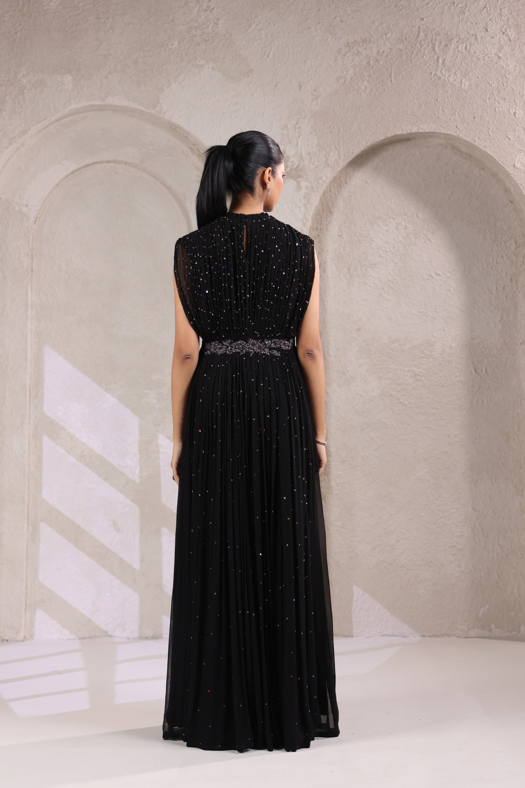 BLACK EMBELLISHED GOWN WITH INTRICATE WAIST DETAILING.