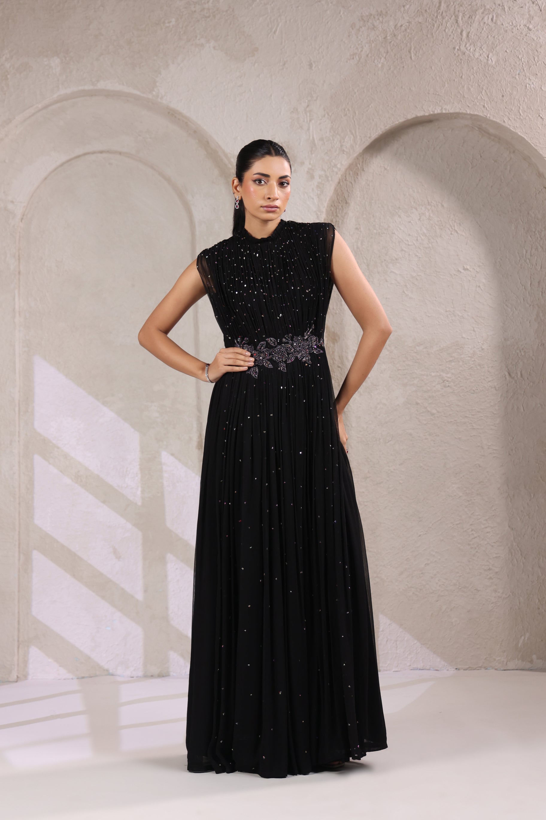 BLACK EMBELLISHED GOWN WITH INTRICATE WAIST DETAILING.