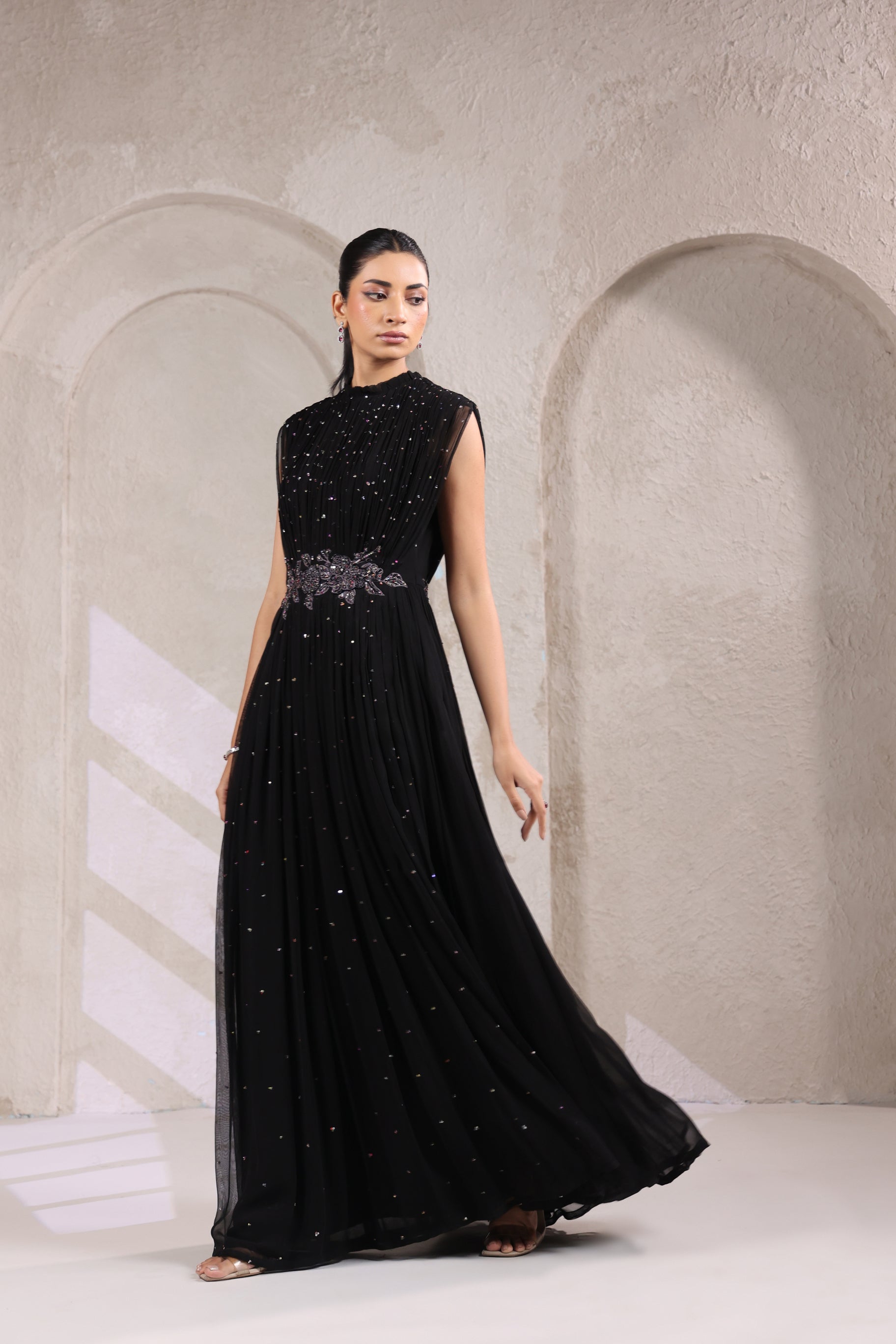 BLACK EMBELLISHED GOWN WITH INTRICATE WAIST DETAILING.