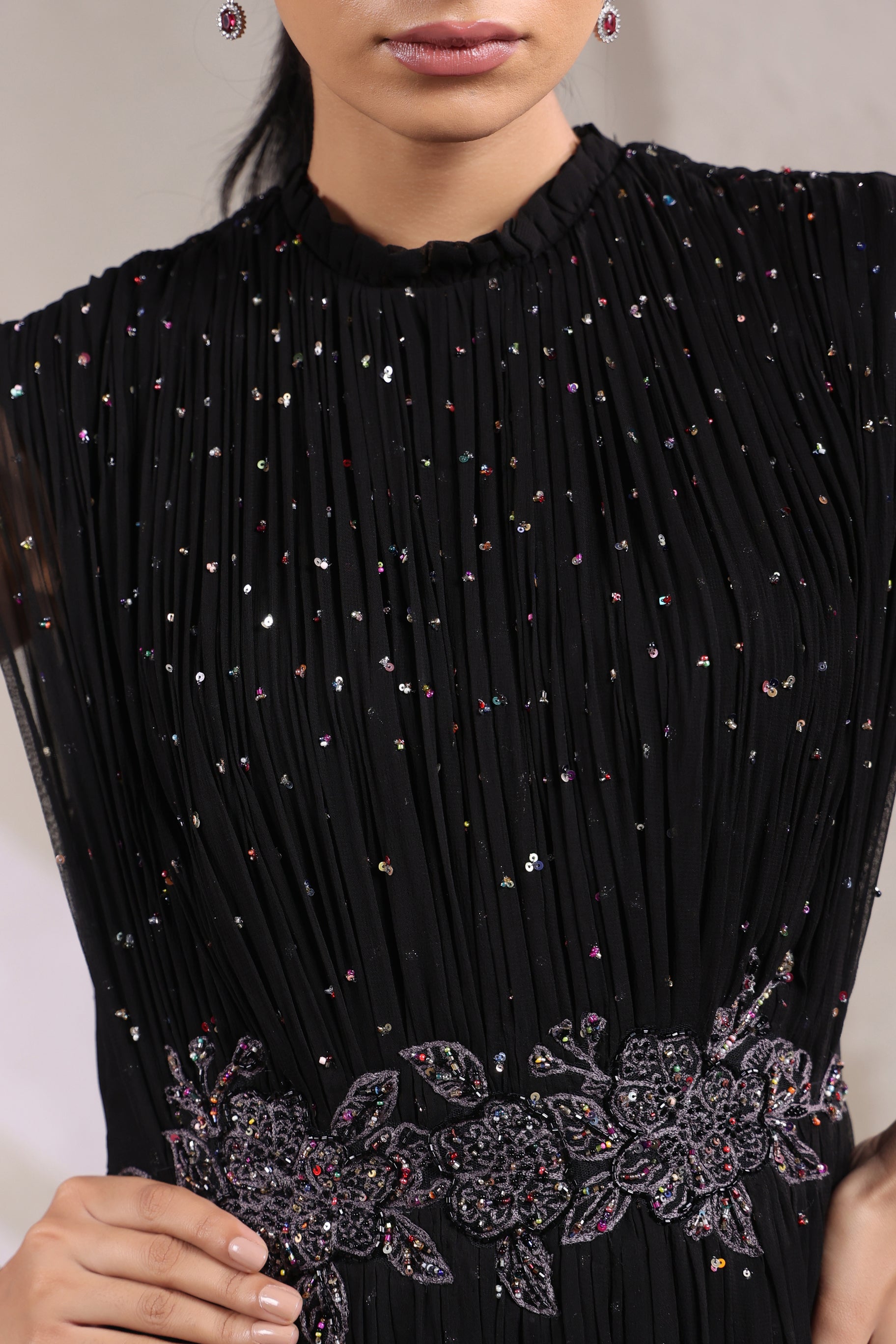 BLACK EMBELLISHED GOWN WITH INTRICATE WAIST DETAILING.