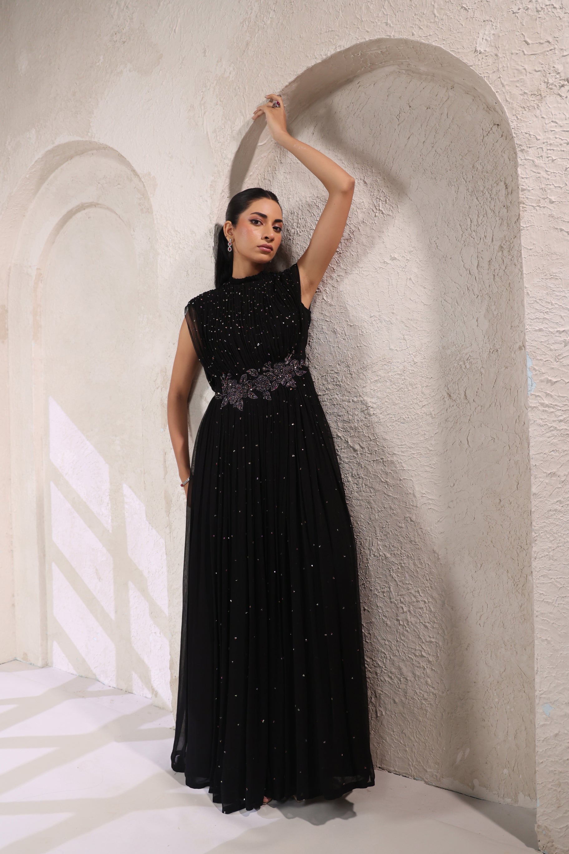BLACK EMBELLISHED GOWN WITH INTRICATE WAIST DETAILING.
