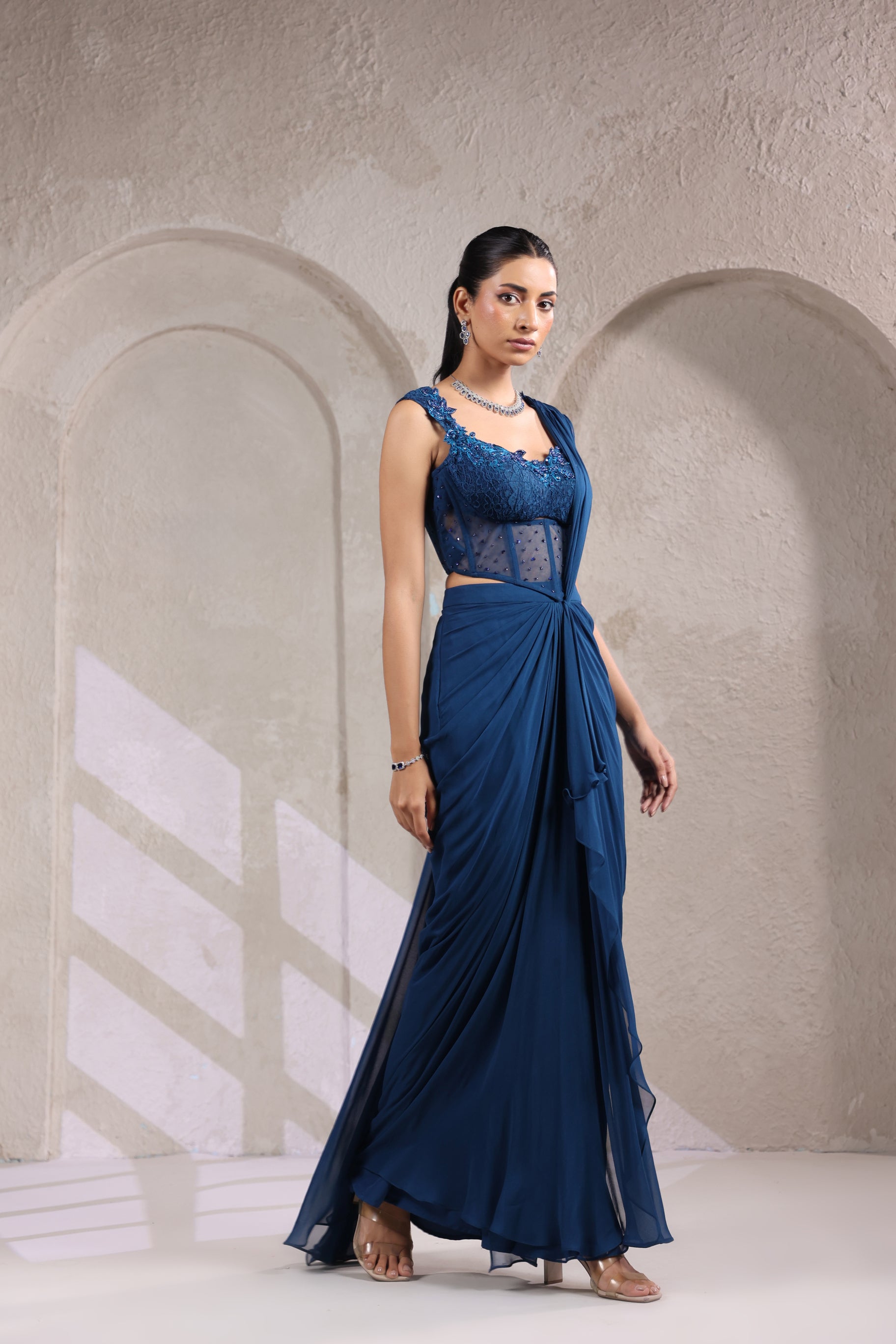 MIDNIGHT TEAL BLUE CORSET DRAPE SAREE WITH FLORAL NECKLINE.