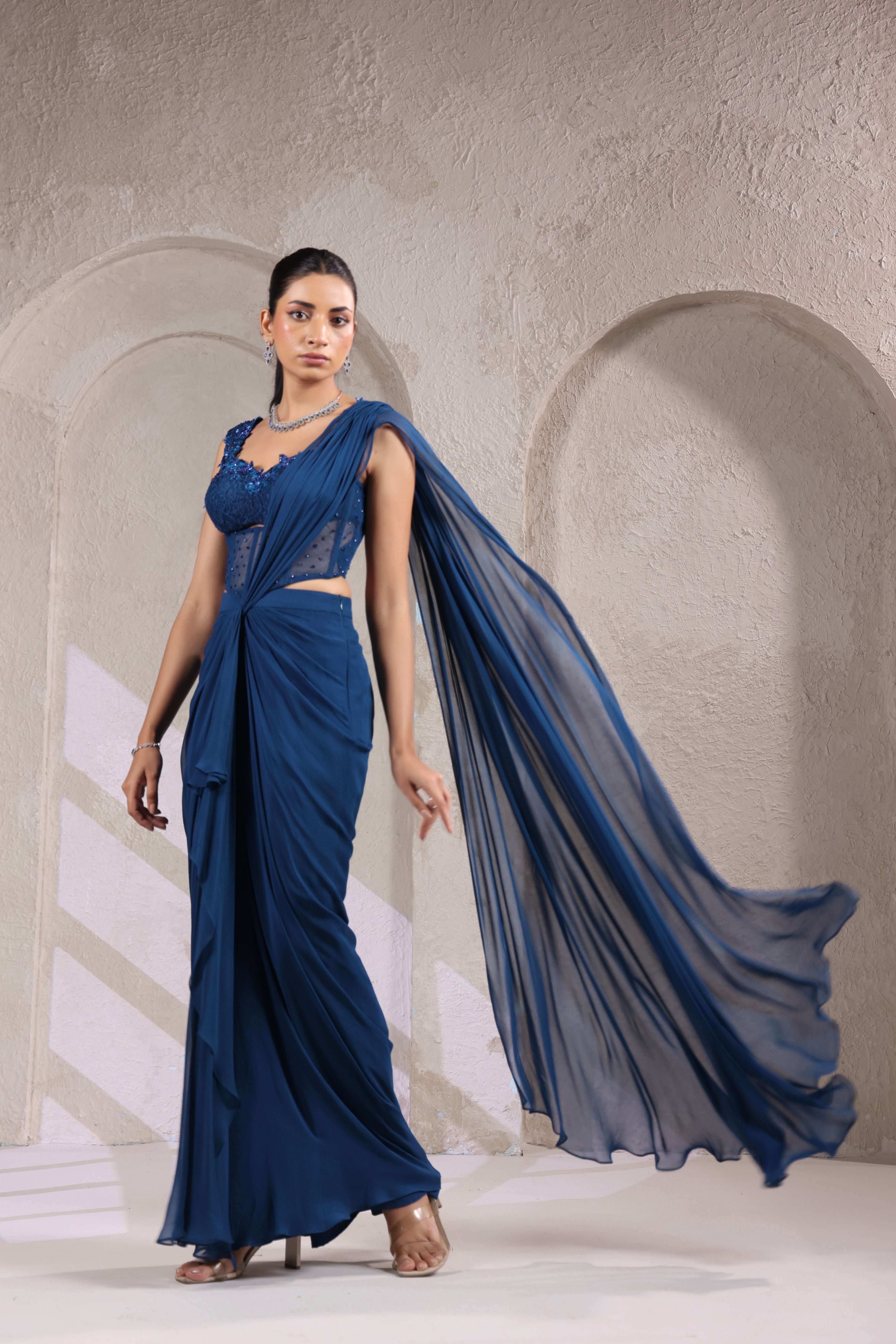 MIDNIGHT TEAL BLUE CORSET DRAPE SAREE WITH FLORAL NECKLINE.
