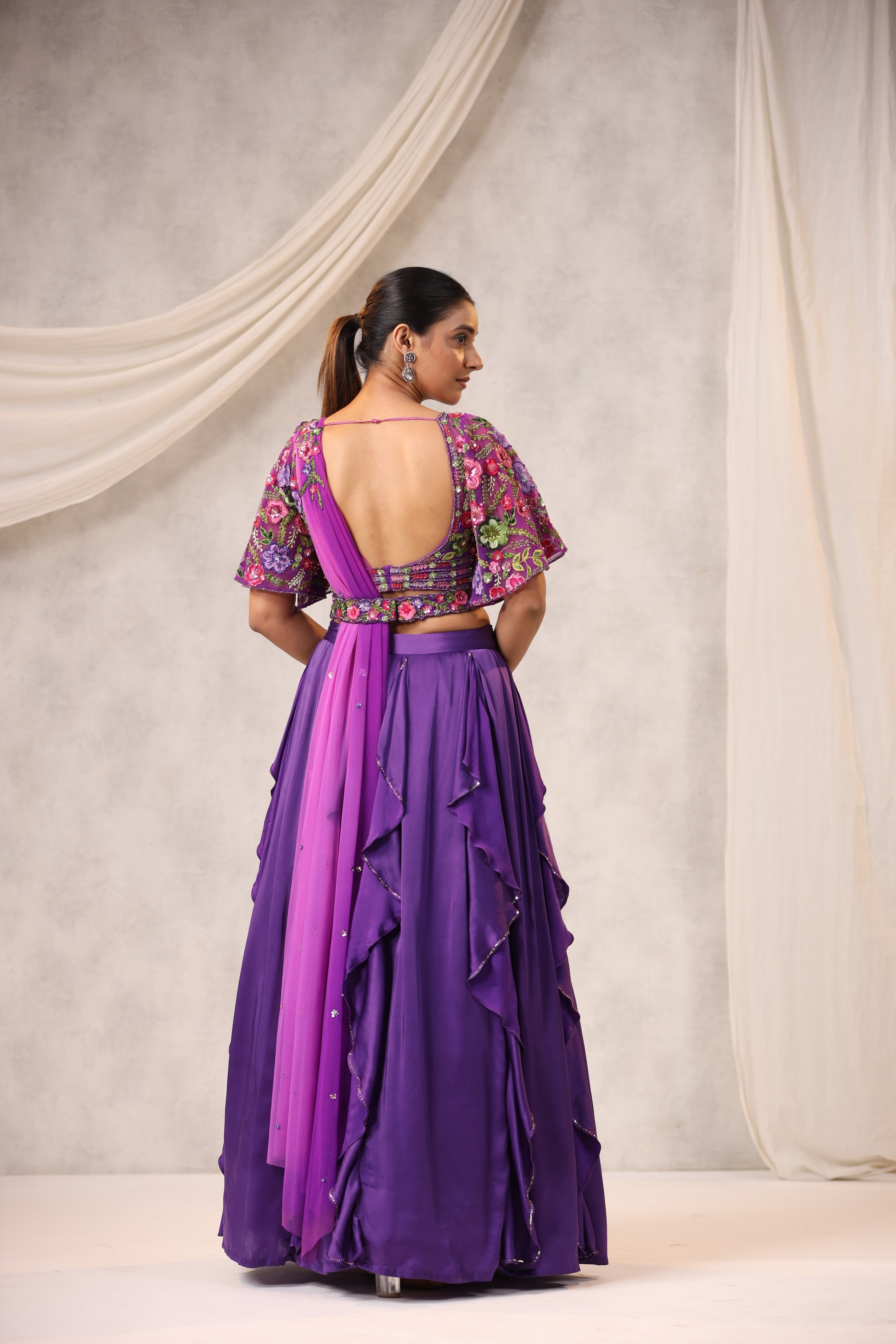 PURPLE RUFFLE LEHENGA WITH AN EMBROIDERED FLORAL BLOUSE