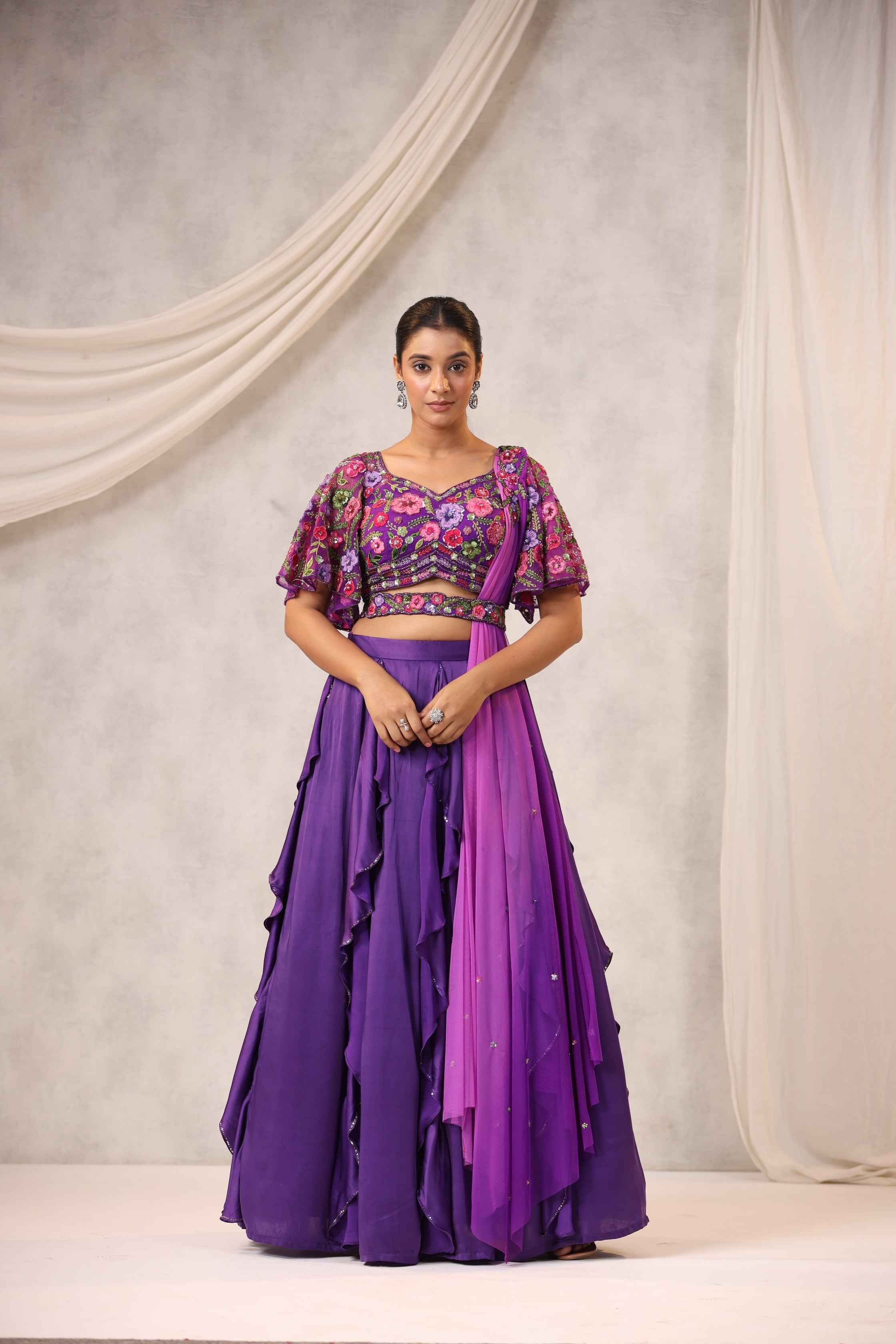 PURPLE RUFFLE LEHENGA WITH AN EMBROIDERED FLORAL BLOUSE