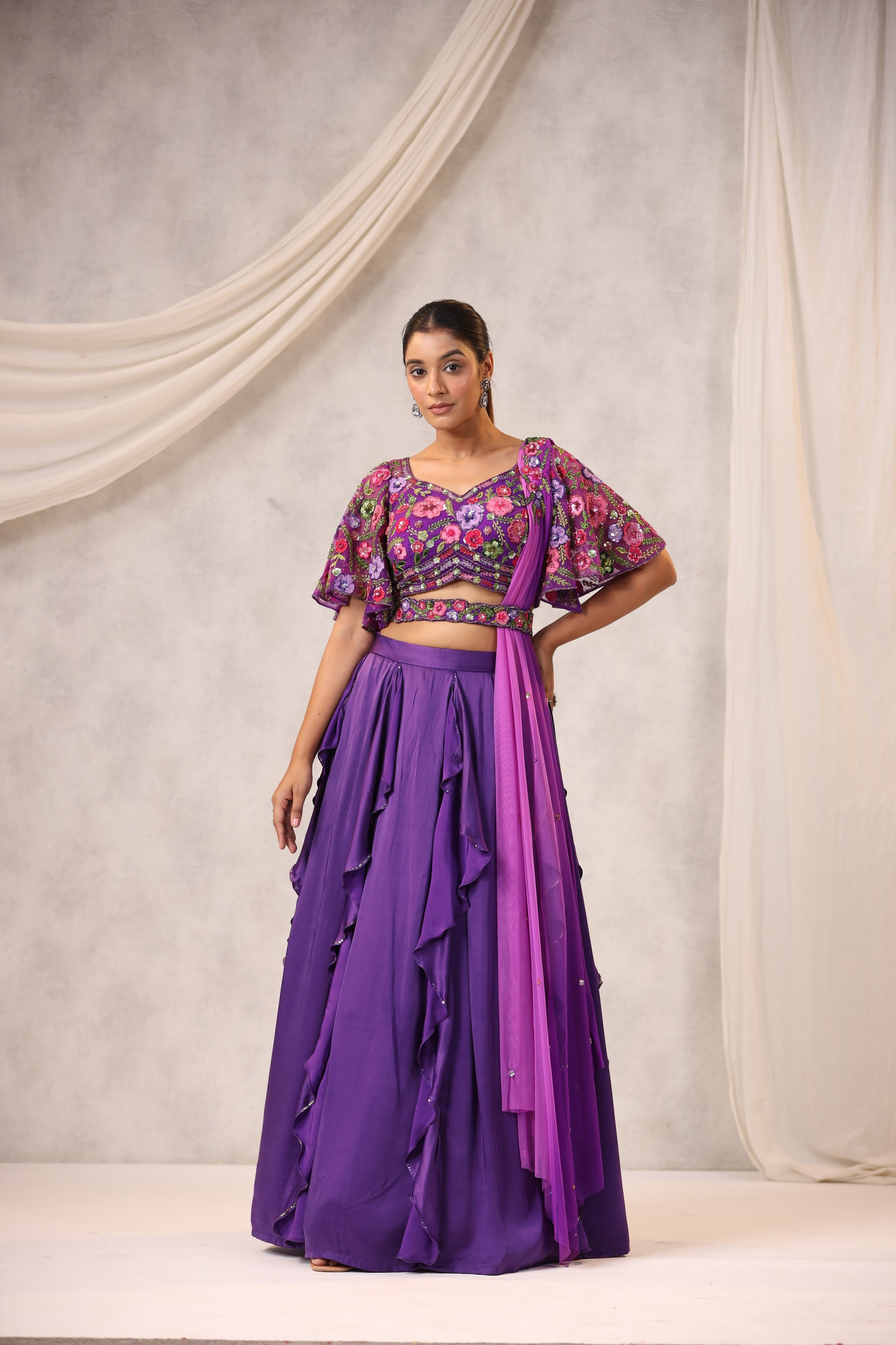 PURPLE RUFFLE LEHENGA WITH AN EMBROIDERED FLORAL BLOUSE
