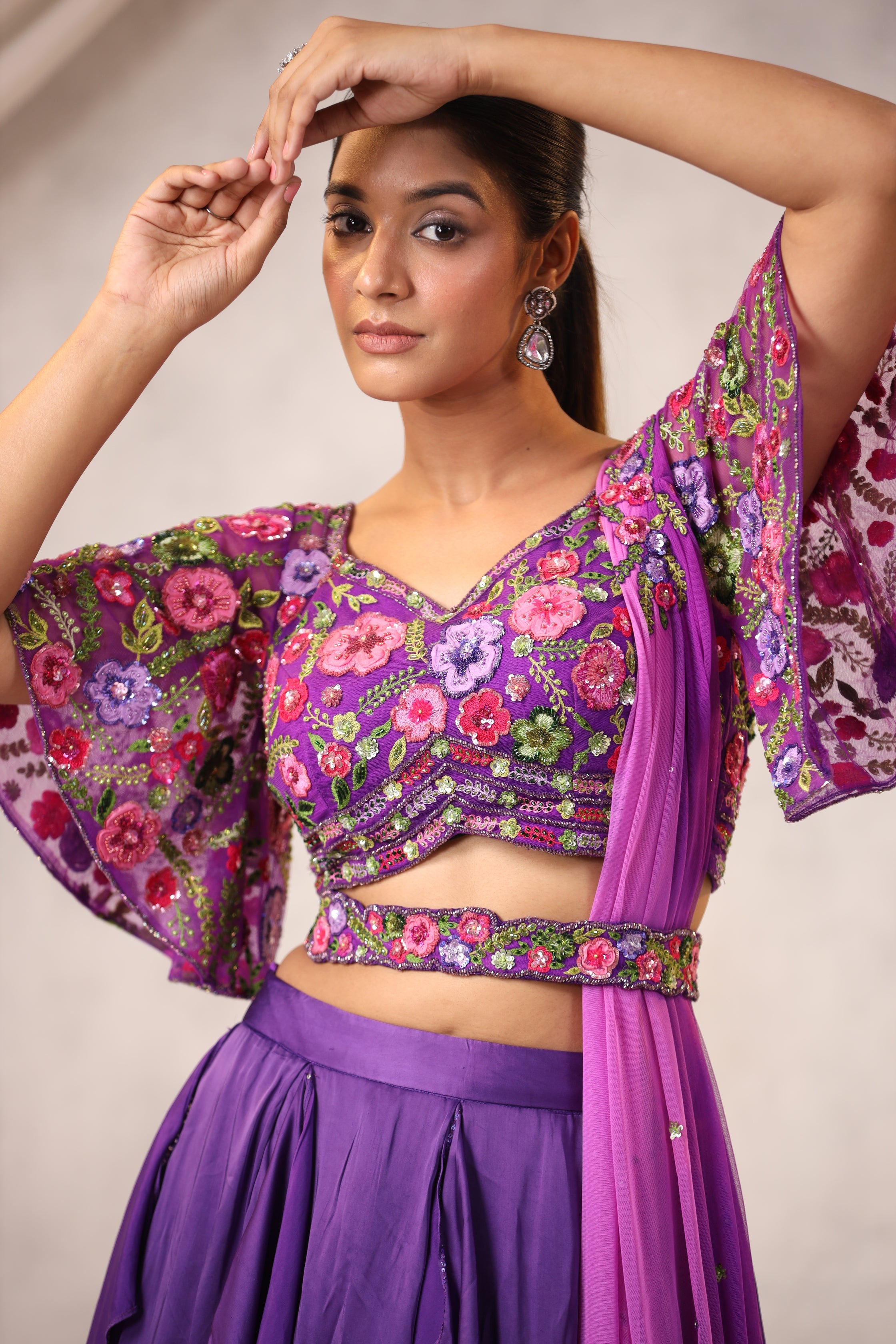 PURPLE RUFFLE LEHENGA WITH AN EMBROIDERED FLORAL BLOUSE