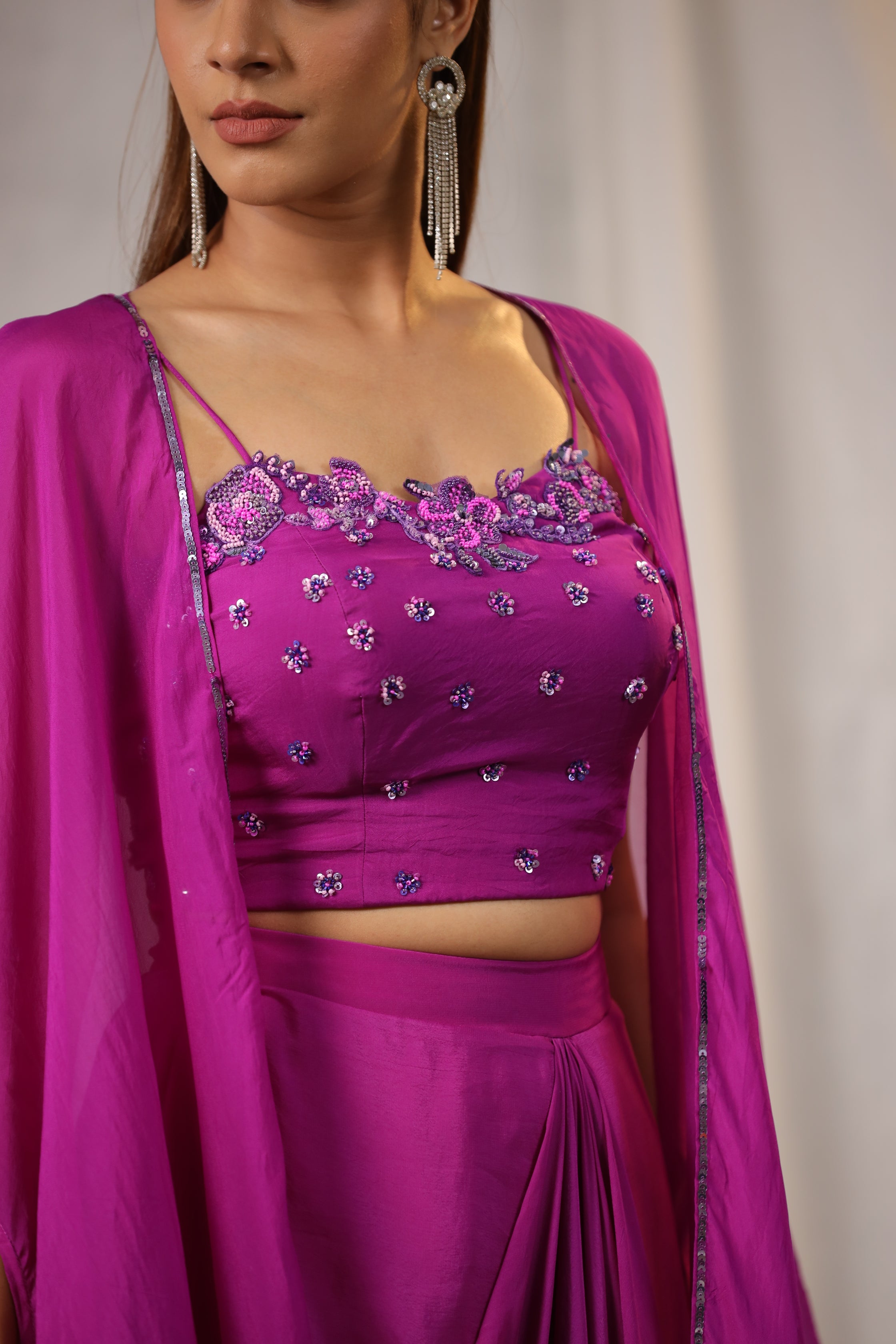 PURPLE EMBROIDERED BUSTIER WITH DRAPED SKIRT AND ORGANZA CAPE AND HAND WORK EDGING