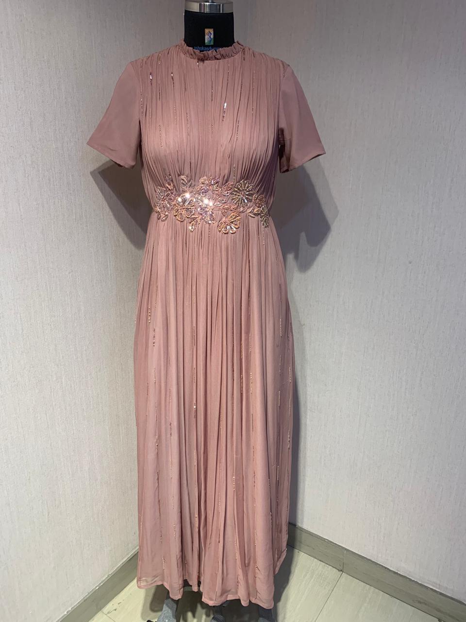 PINK GEORGETTE GOWN WITH APPLIQUE FLOWERS AT THE WAIST.