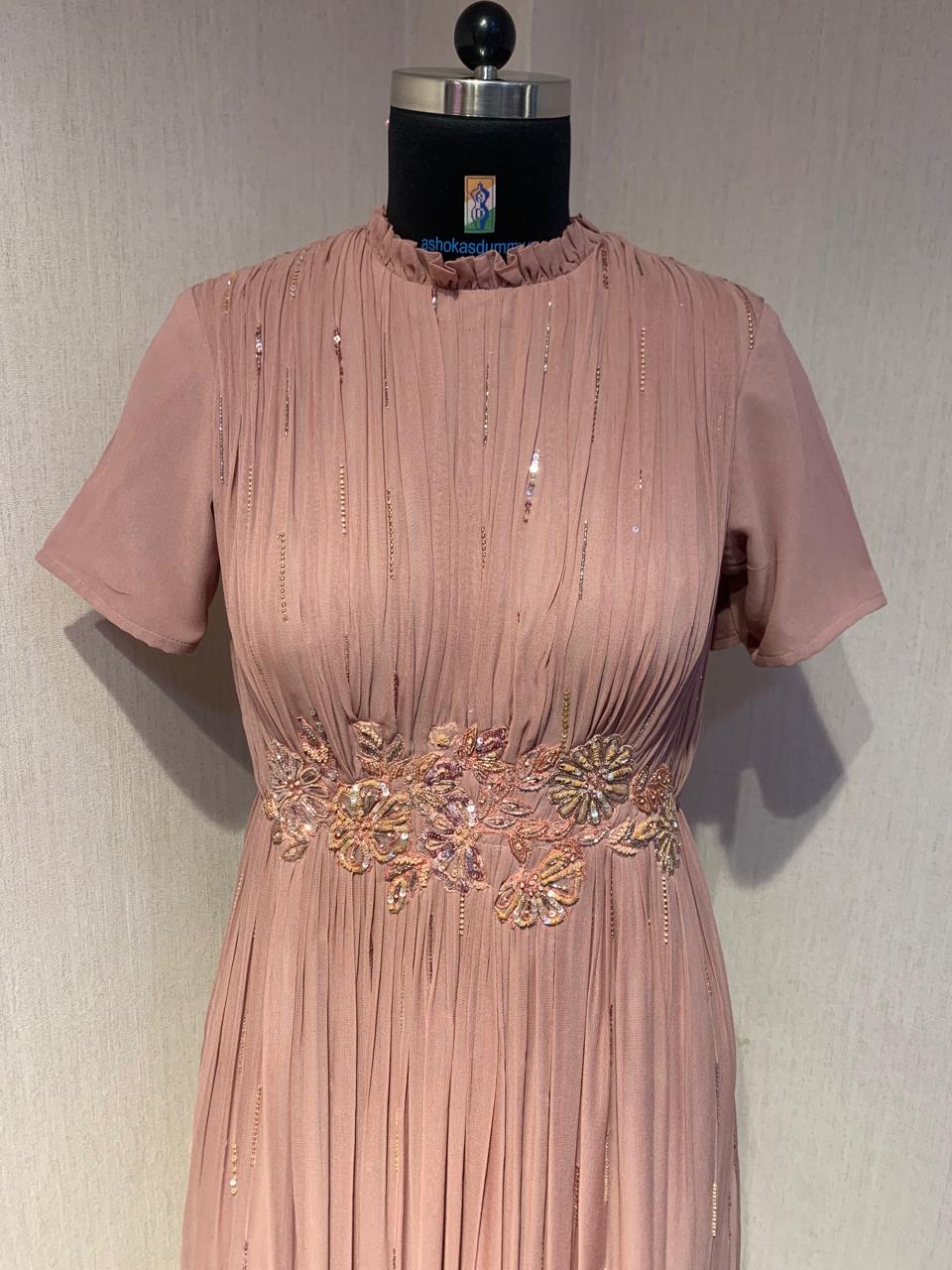 PINK GEORGETTE GOWN WITH APPLIQUE FLOWERS AT THE WAIST.