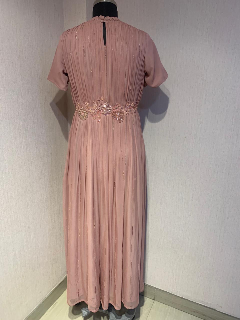 PINK GEORGETTE GOWN WITH APPLIQUE FLOWERS AT THE WAIST.