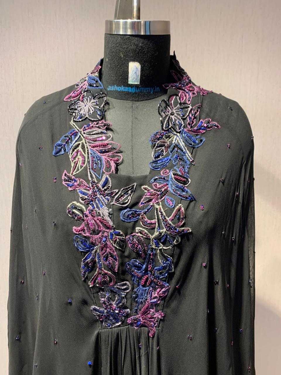 ELEGANT BLACK CAPE TOP WITH FLARED PALAZZO PANTS.