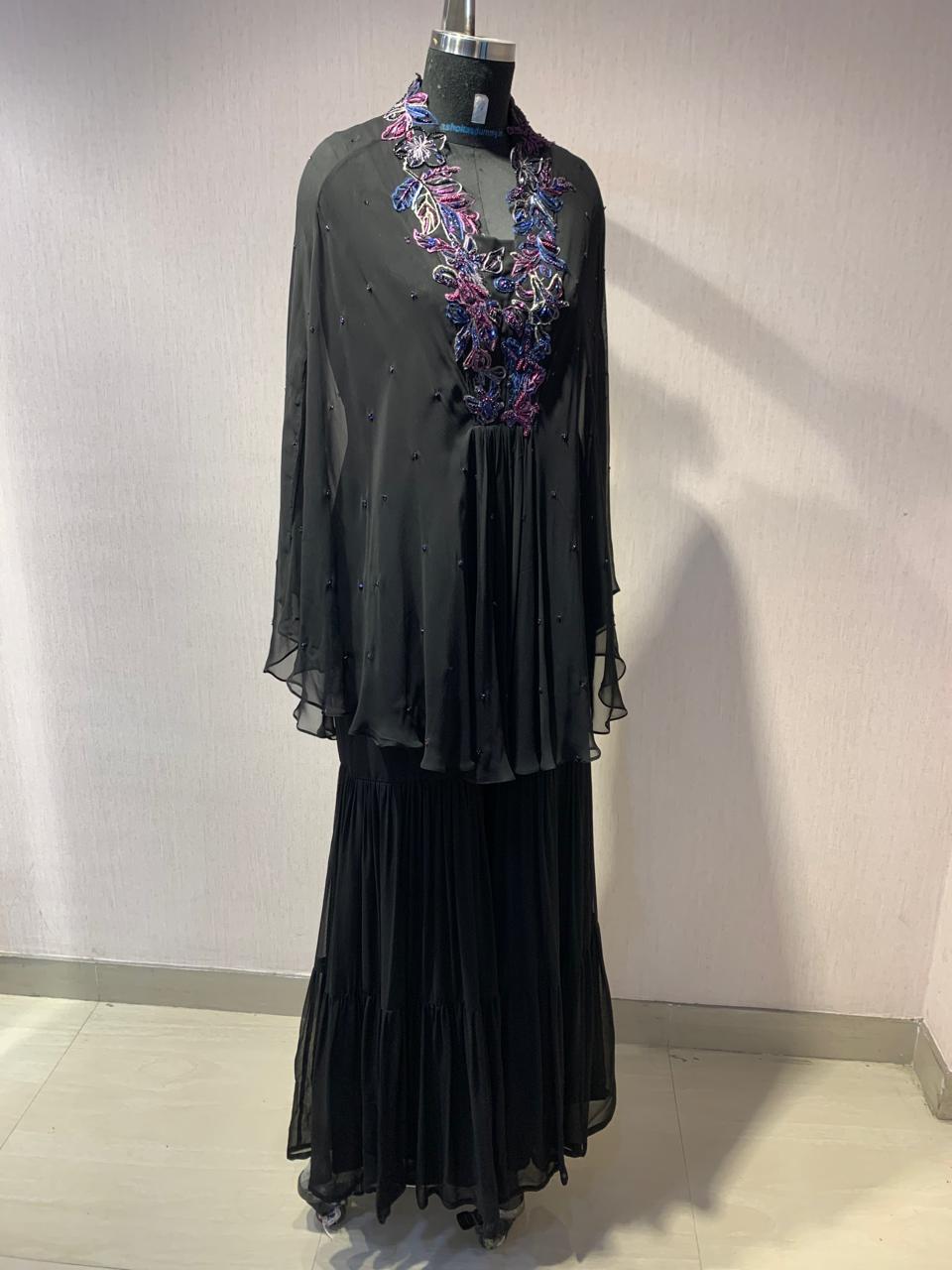 ELEGANT BLACK CAPE TOP WITH FLARED PALAZZO PANTS.