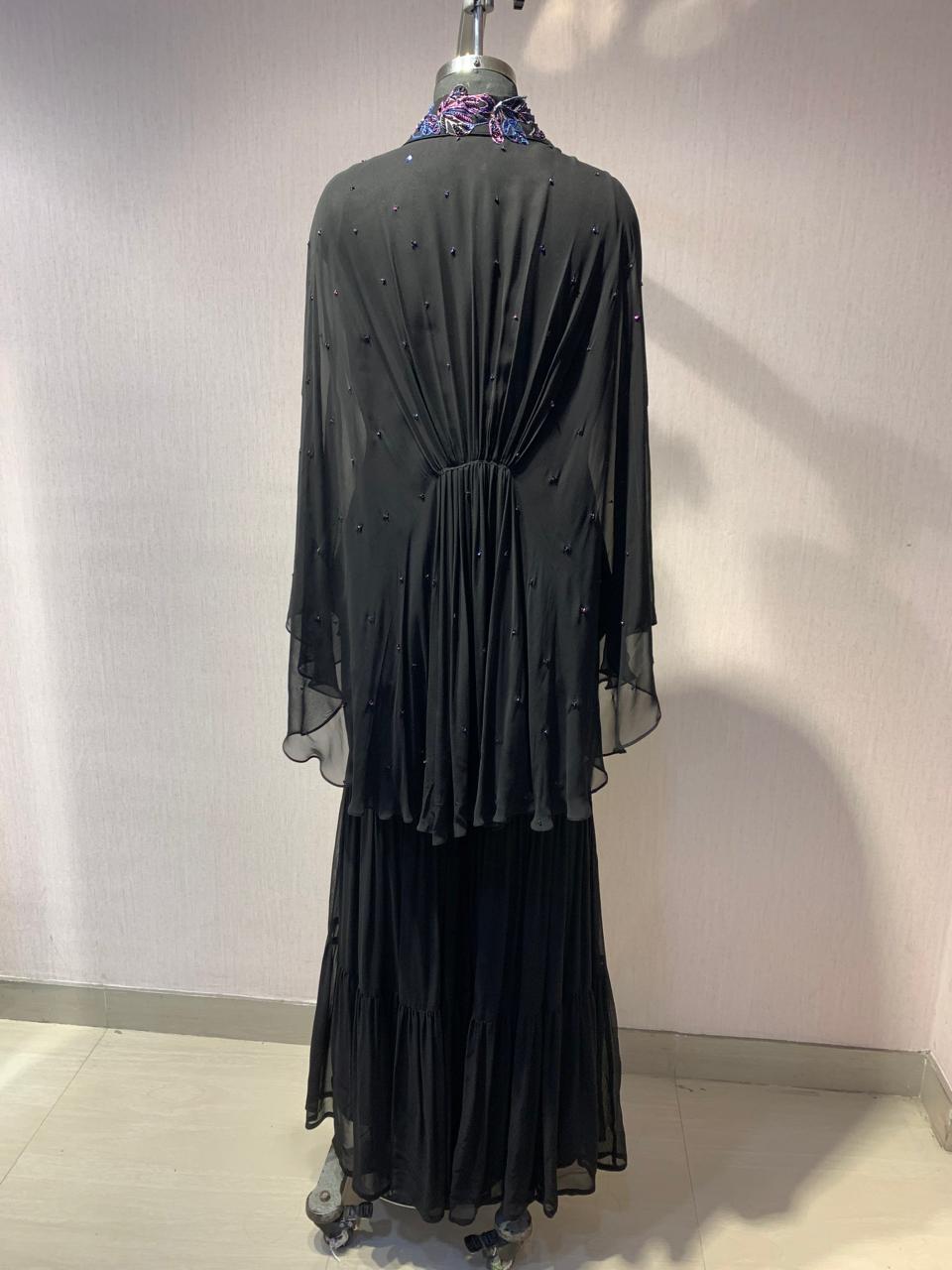 ELEGANT BLACK CAPE TOP WITH FLARED PALAZZO PANTS.