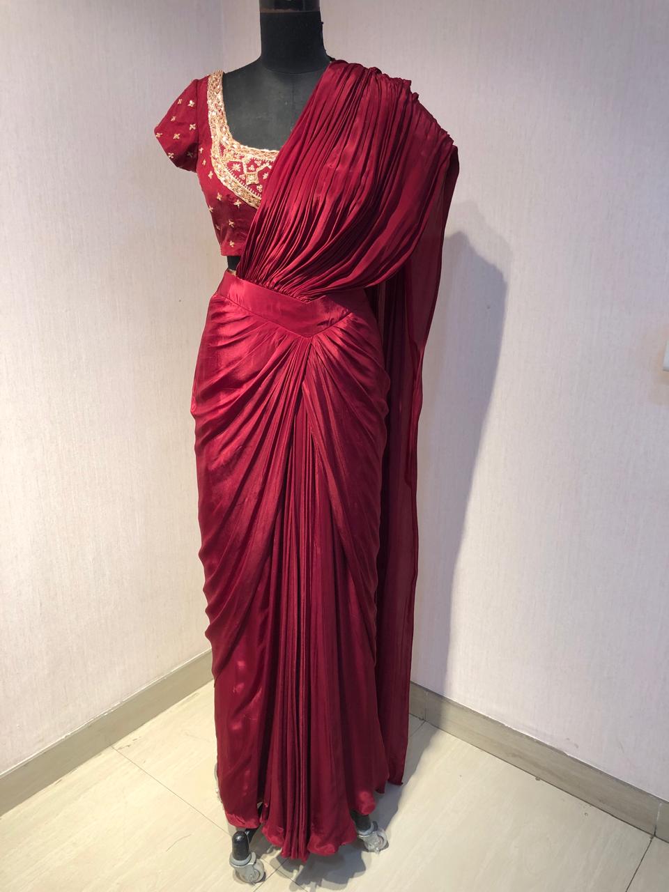 RED DRAPE SAREE WITH EMBRIODERED BLOUSE.