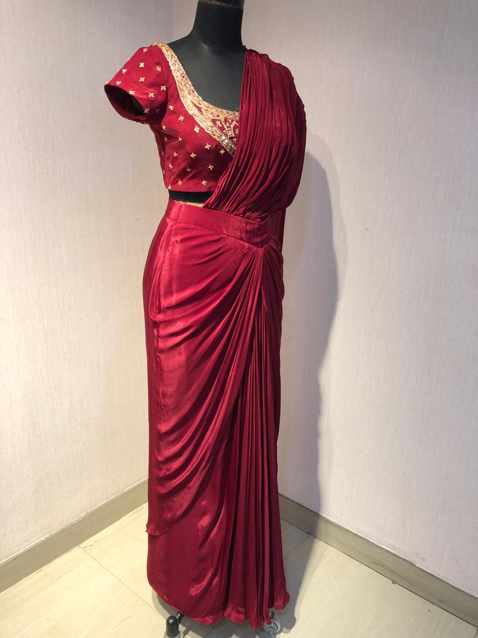 RED DRAPE SAREE WITH EMBRIODERED BLOUSE.