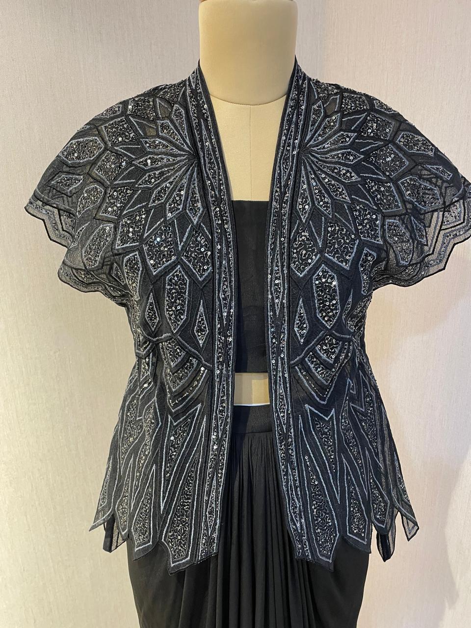 BLACK SKIRT & TOP WITH EMBELLISHED BELTED JACKET.