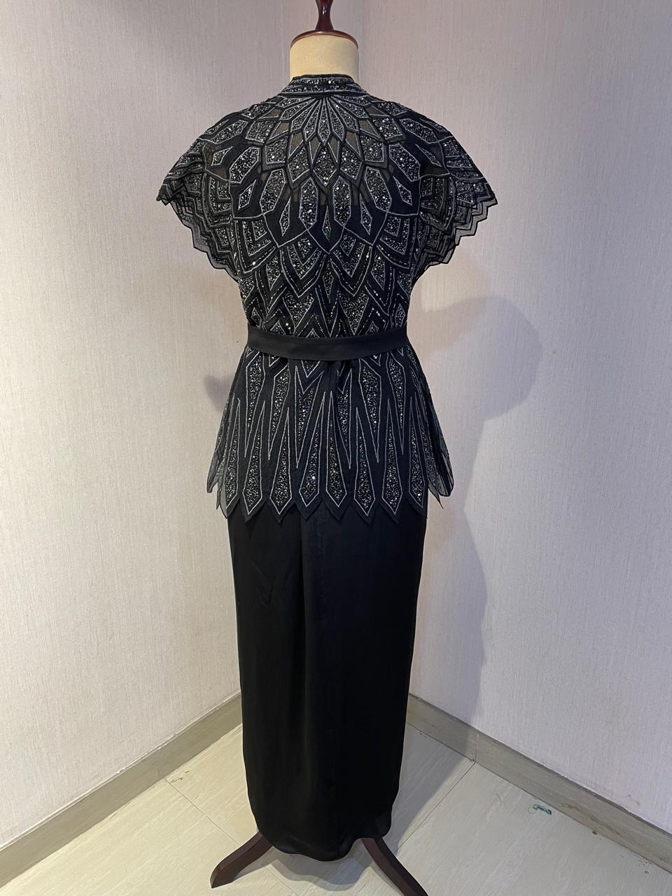 BLACK SKIRT & TOP WITH EMBELLISHED BELTED JACKET.