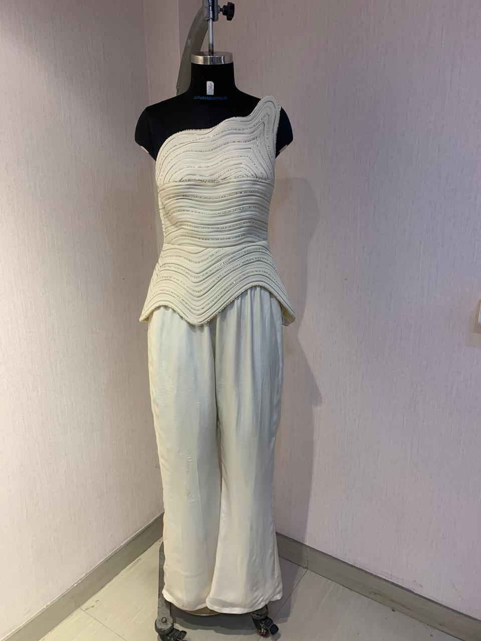 IVORY ONE-SHOULDER TEXTURED CO-ORD SET WITH FLARED PANTS.