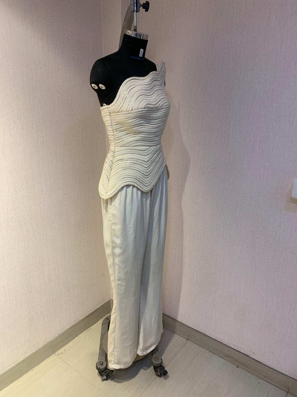 IVORY ONE-SHOULDER TEXTURED CO-ORD SET WITH FLARED PANTS.