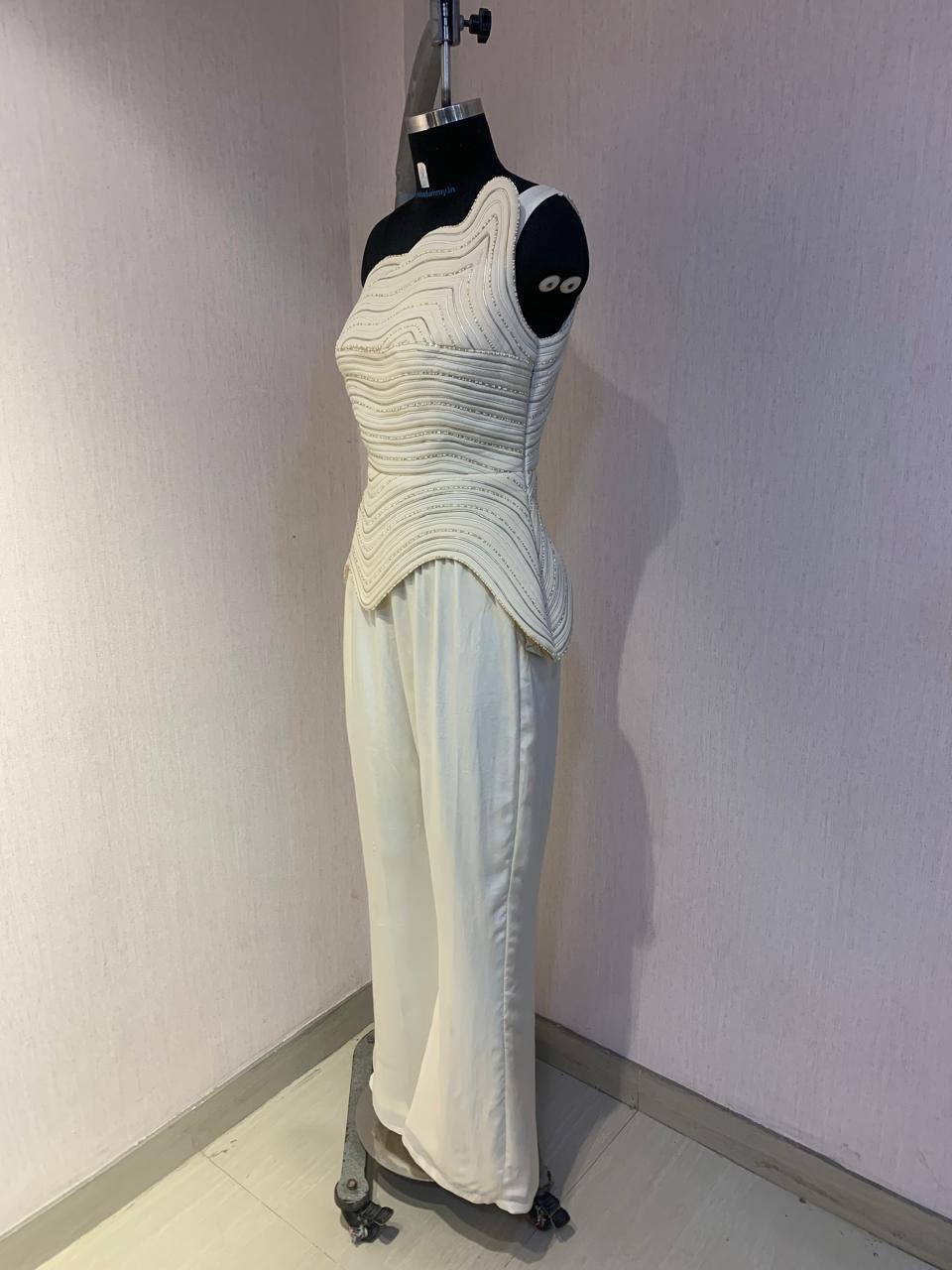 IVORY ONE-SHOULDER TEXTURED CO-ORD SET WITH FLARED PANTS.