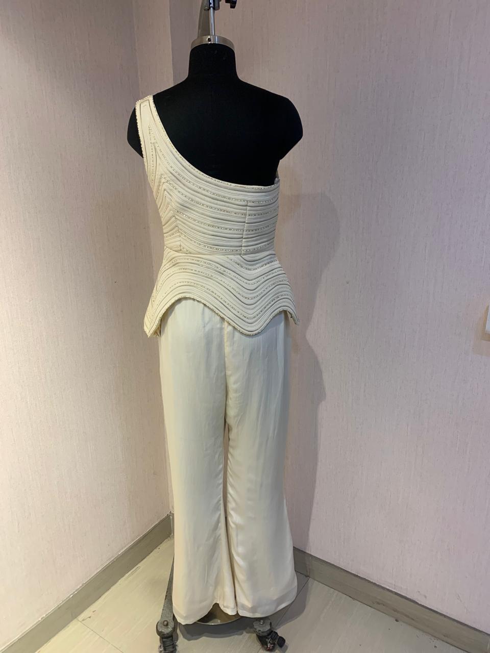 IVORY ONE-SHOULDER TEXTURED CO-ORD SET WITH FLARED PANTS.