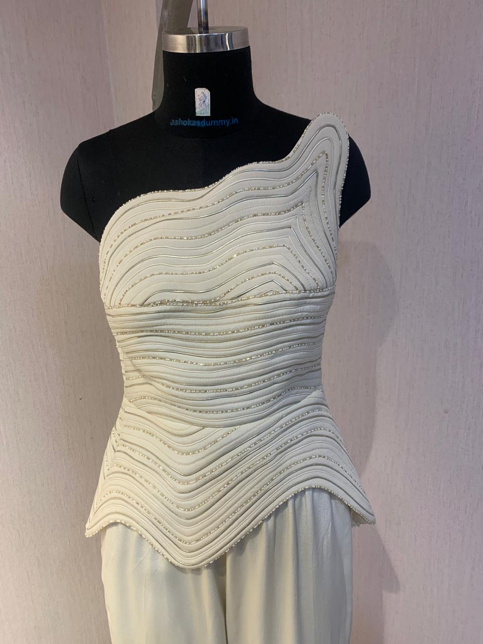 IVORY ONE-SHOULDER TEXTURED CO-ORD SET WITH FLARED PANTS.