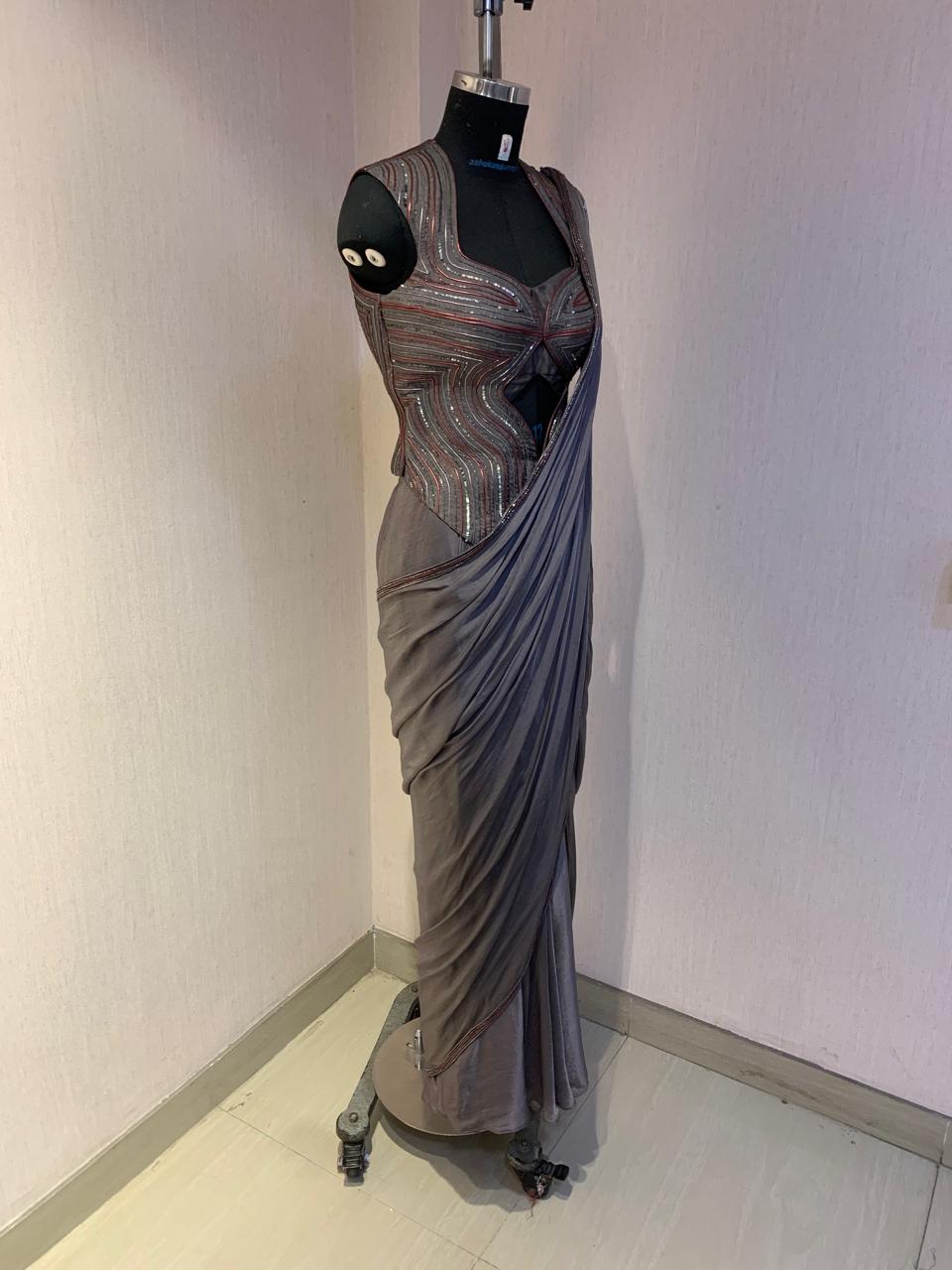 GREY SEQUIN AND EMBELLISHED PRE-DRAPED SAREE WITH DESIGNER CUT-OUT BLOUSE.