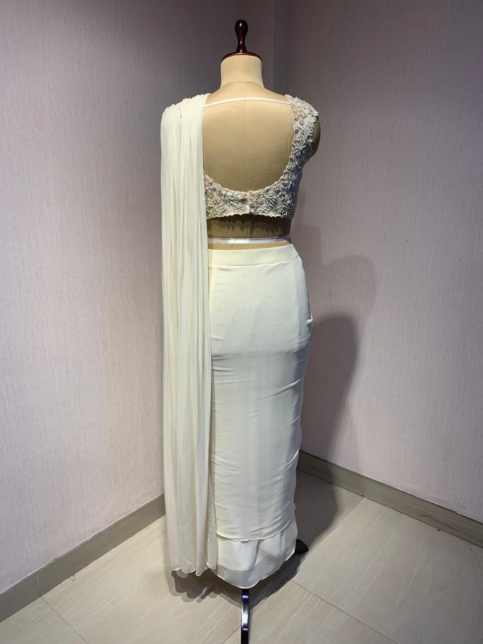 OFF WHITE DRAPE SAREE WITH APPLIQUE FLORAL WORK BLOUSE.