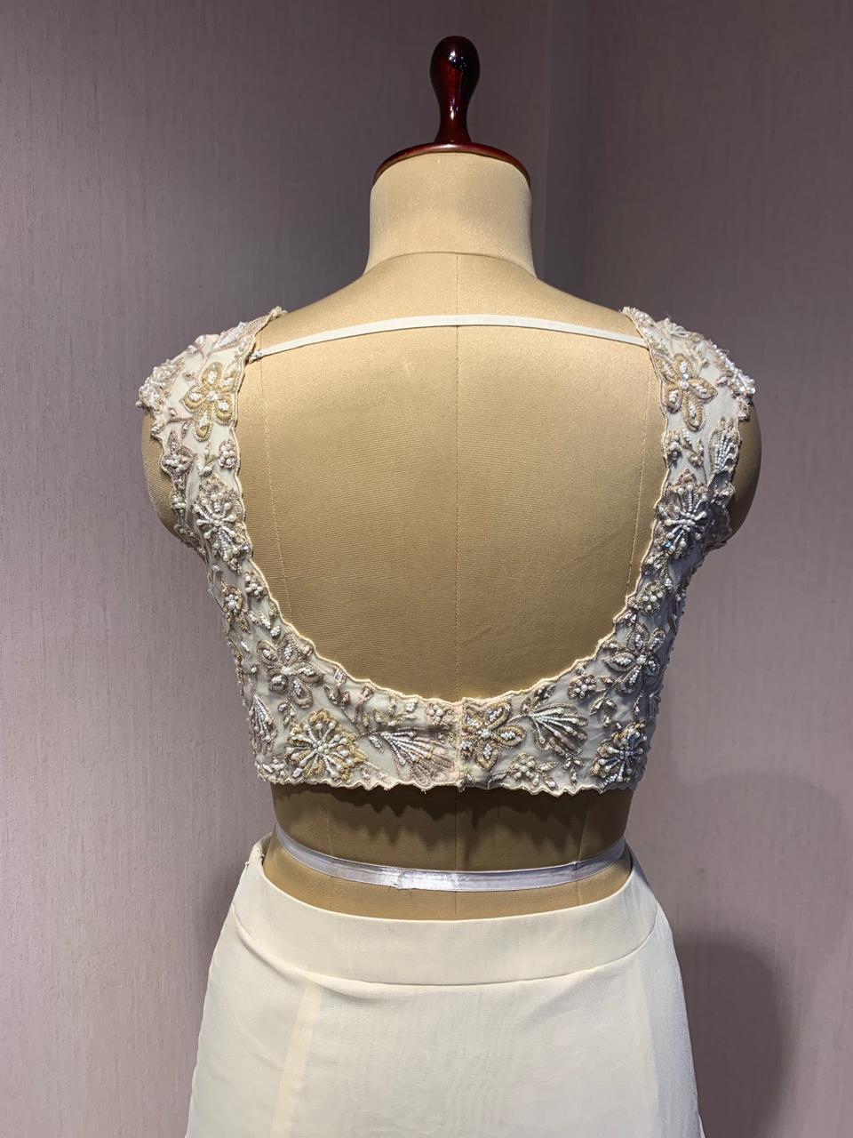 OFF WHITE DRAPE SAREE WITH APPLIQUE FLORAL WORK BLOUSE.