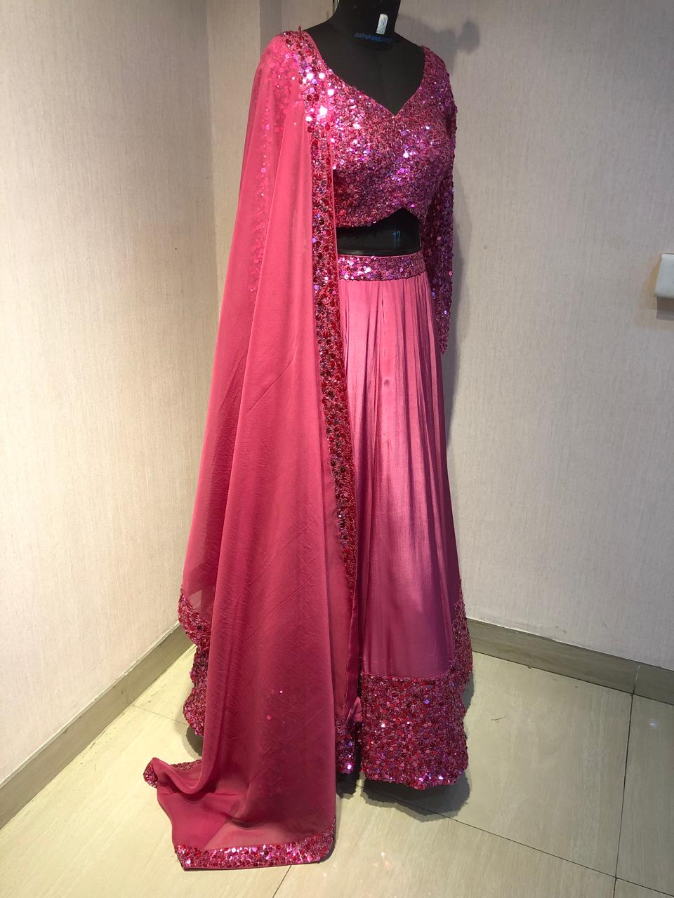 PINK SEQUIN EMBELLISHED LEHENGA SET WITH MATCHING BLOUSE AND DUPATTA.