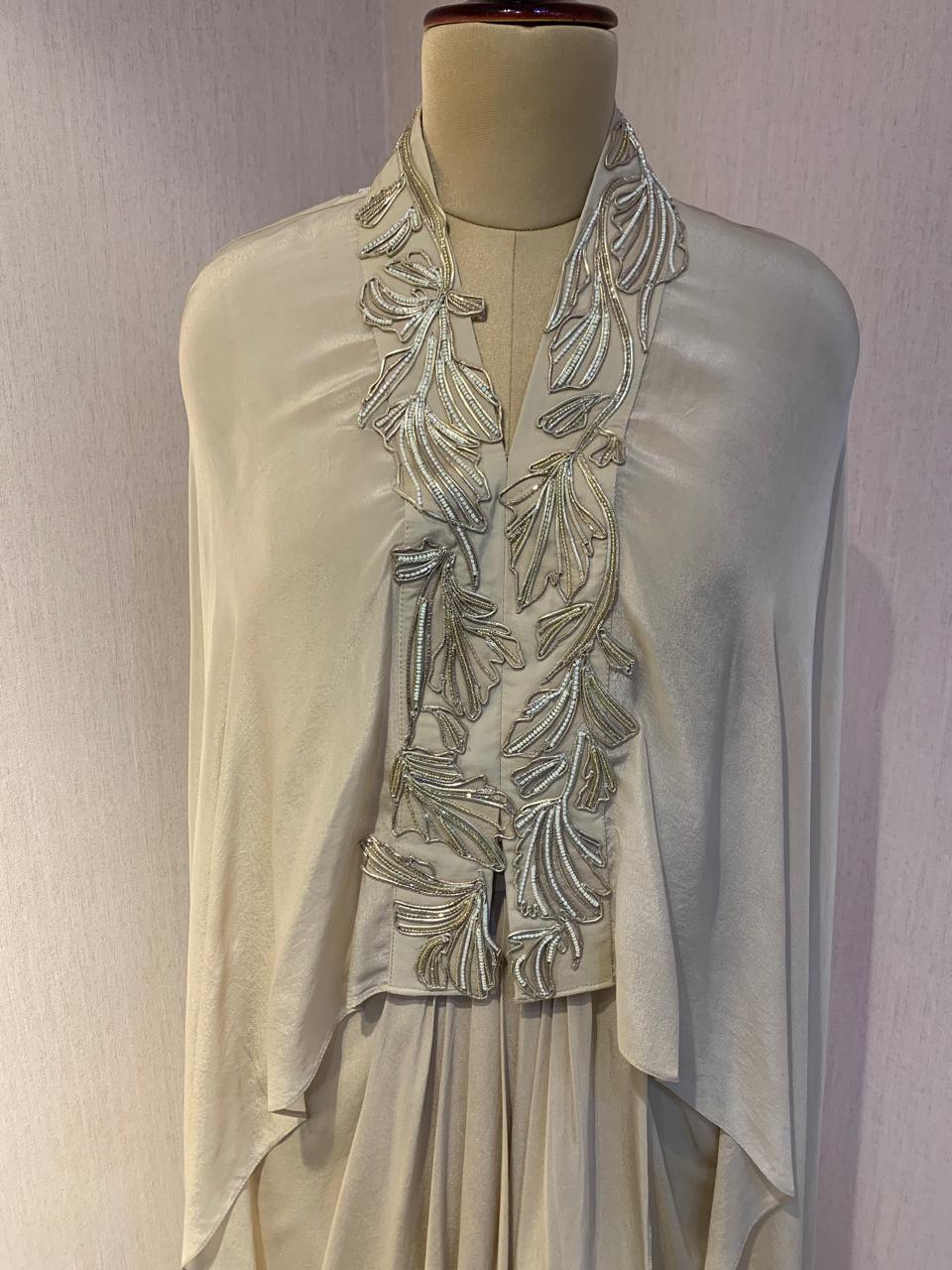 WIRE EMBELLISHED LAYERED TOP WITH INNER AND DRAPED SKIRT.