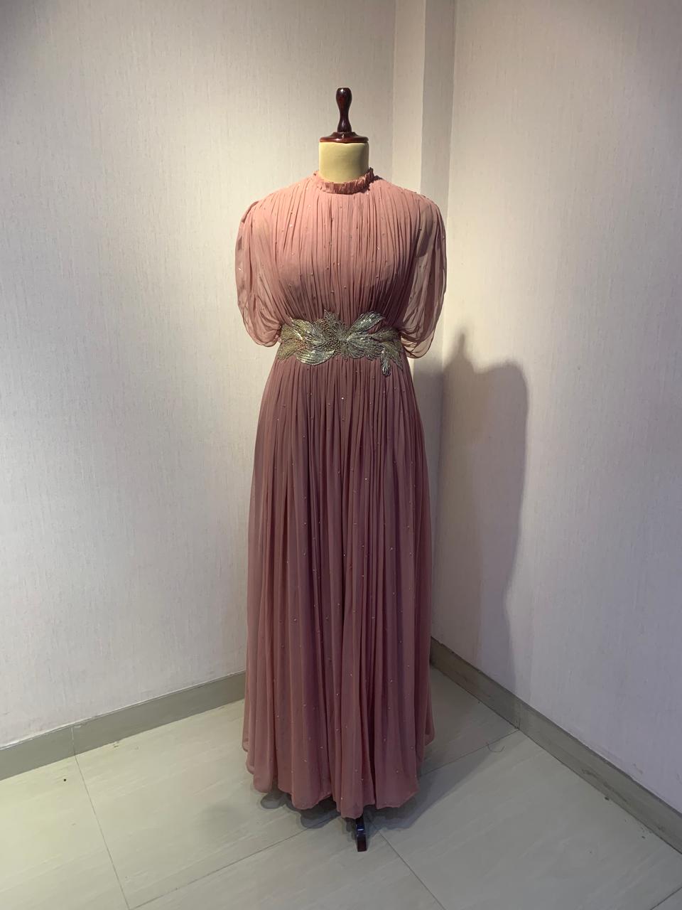 DUSTY ROSE SEQUIN AND WIRE EMBELLISHED PLEATED GOWN WITH SHEER SLEEVES.