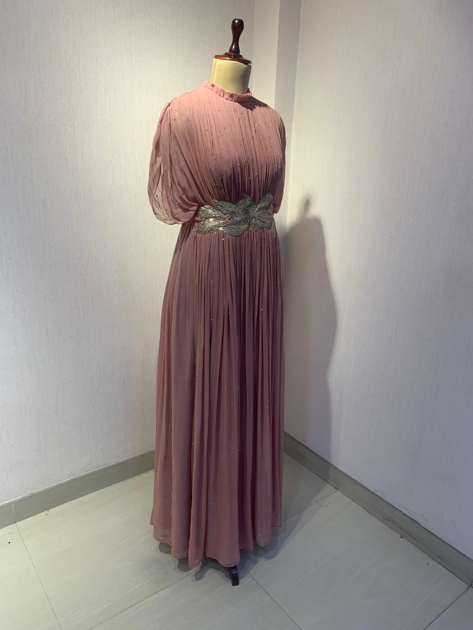DUSTY ROSE SEQUIN AND WIRE EMBELLISHED PLEATED GOWN WITH SHEER SLEEVES.