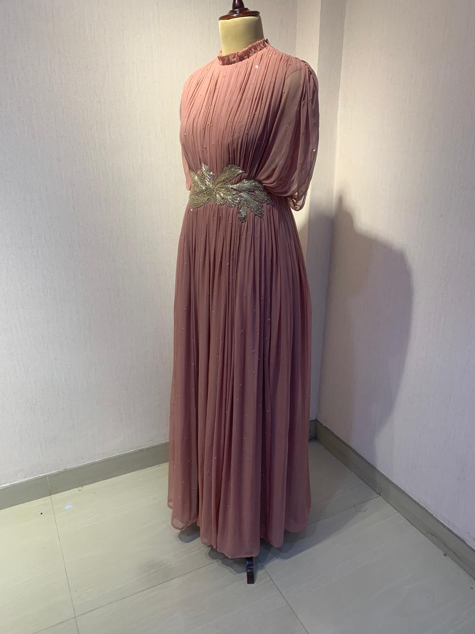 DUSTY ROSE SEQUIN AND WIRE EMBELLISHED PLEATED GOWN WITH SHEER SLEEVES.
