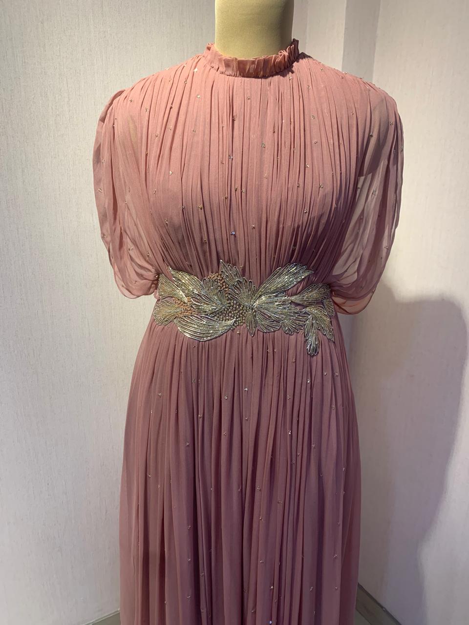 DUSTY ROSE SEQUIN AND WIRE EMBELLISHED PLEATED GOWN WITH SHEER SLEEVES.