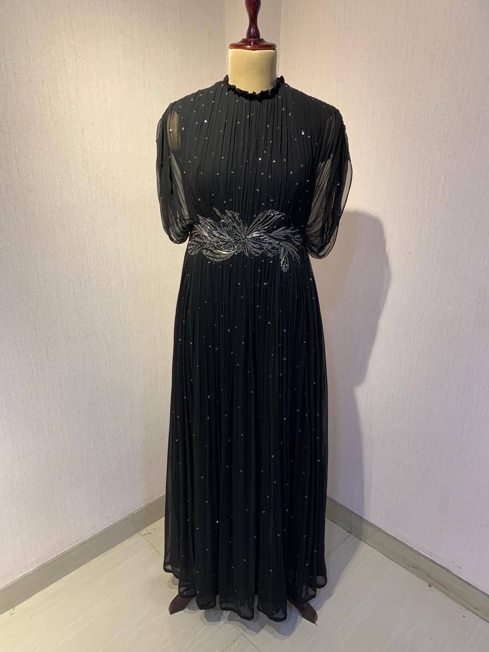 BLACK SEQUIN AND WIRE EMBELLISHED PLEATED GOWN WITH SHEER SLEEVES.