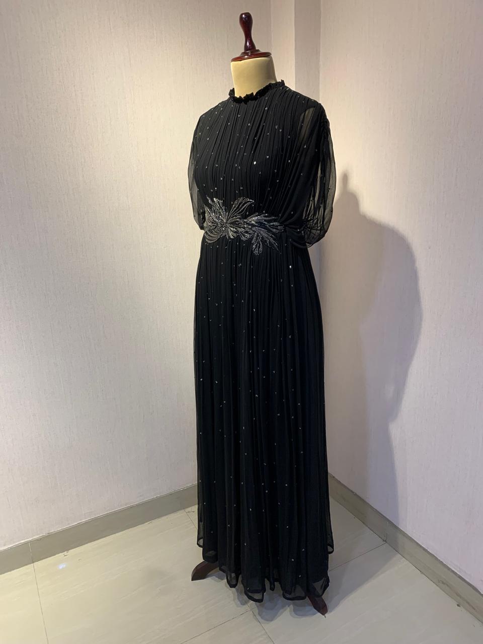 BLACK SEQUIN AND WIRE EMBELLISHED PLEATED GOWN WITH SHEER SLEEVES.