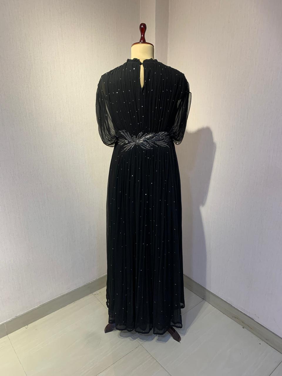 BLACK SEQUIN AND WIRE EMBELLISHED PLEATED GOWN WITH SHEER SLEEVES.