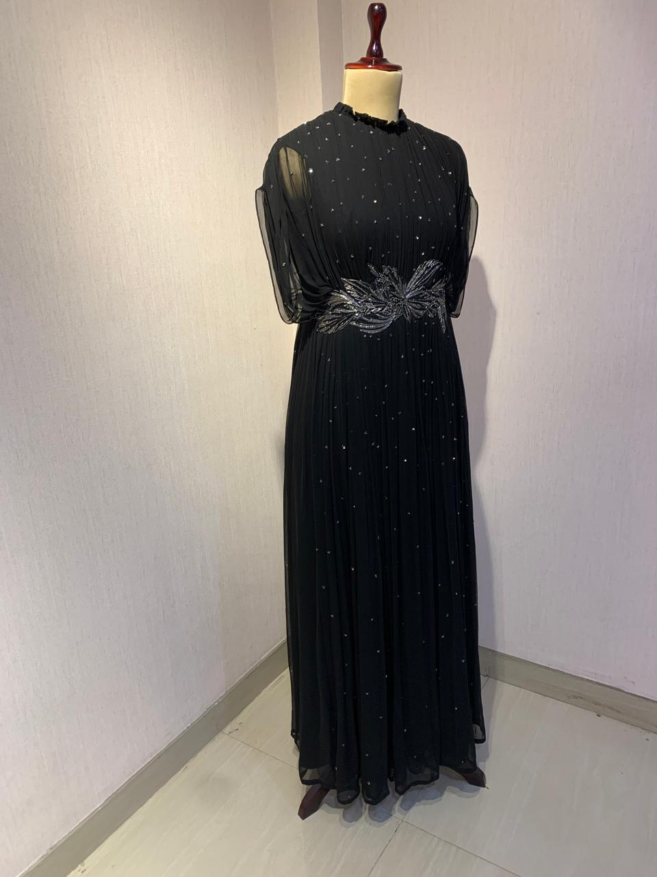 BLACK SEQUIN AND WIRE EMBELLISHED PLEATED GOWN WITH SHEER SLEEVES.