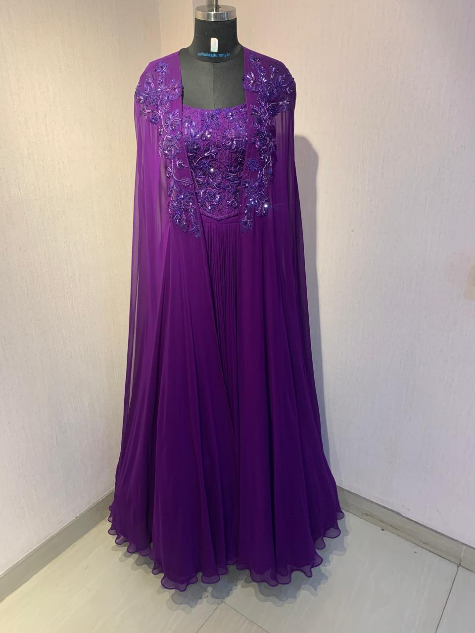 PURPLE EMBROIDERED CORSET TOP WITH FLARED SKIRT AND CAPE.