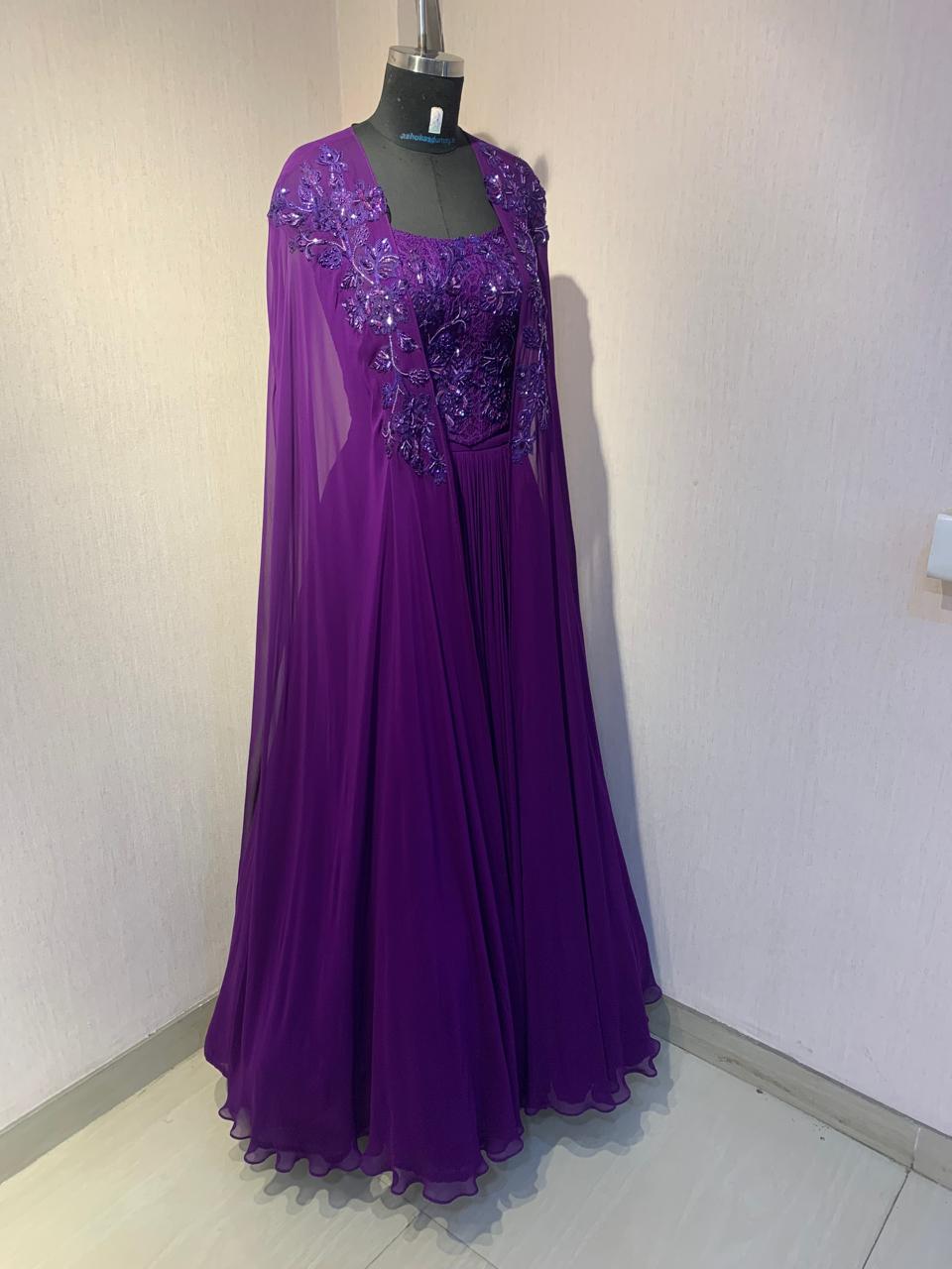PURPLE EMBROIDERED CORSET TOP WITH FLARED SKIRT AND CAPE.