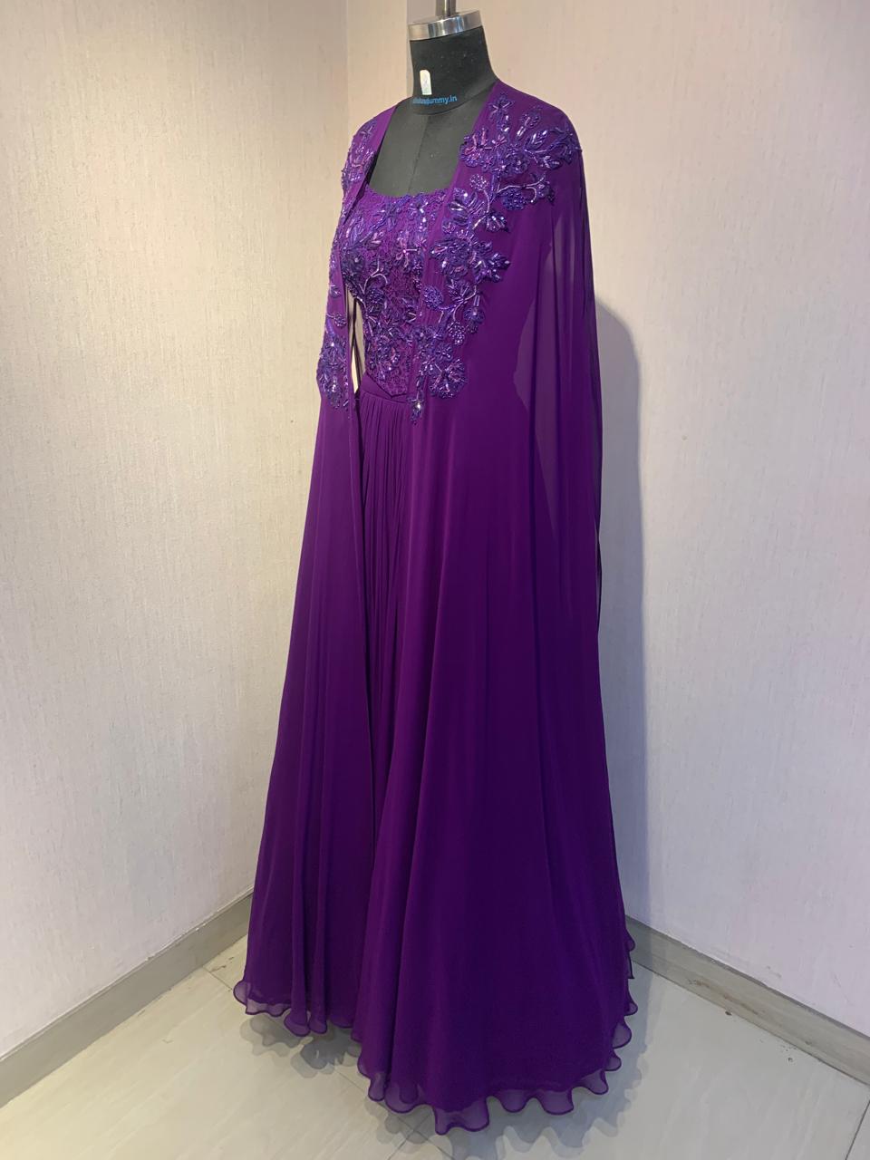 PURPLE EMBROIDERED CORSET TOP WITH FLARED SKIRT AND CAPE.