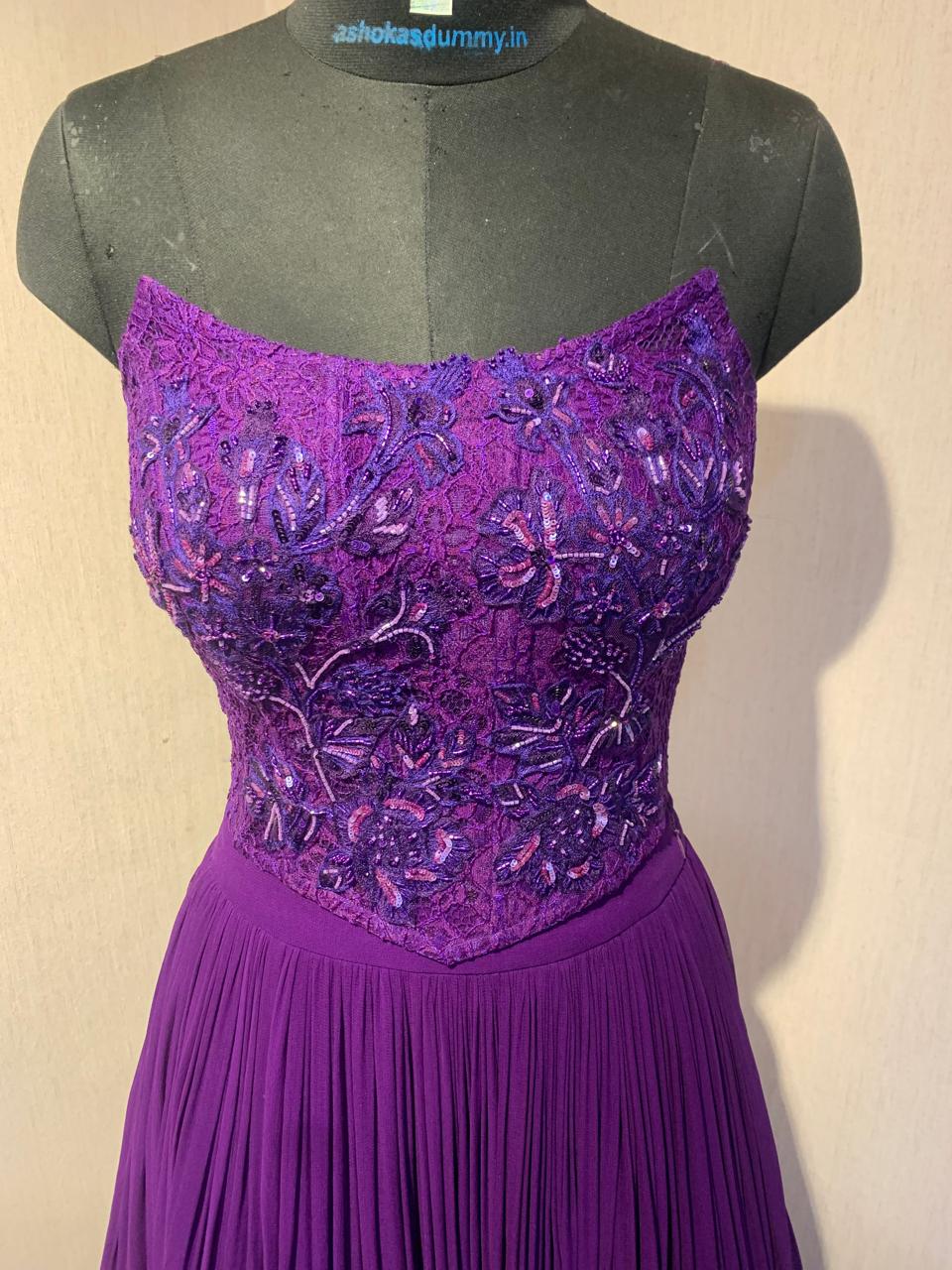 PURPLE EMBROIDERED CORSET TOP WITH FLARED SKIRT AND CAPE.