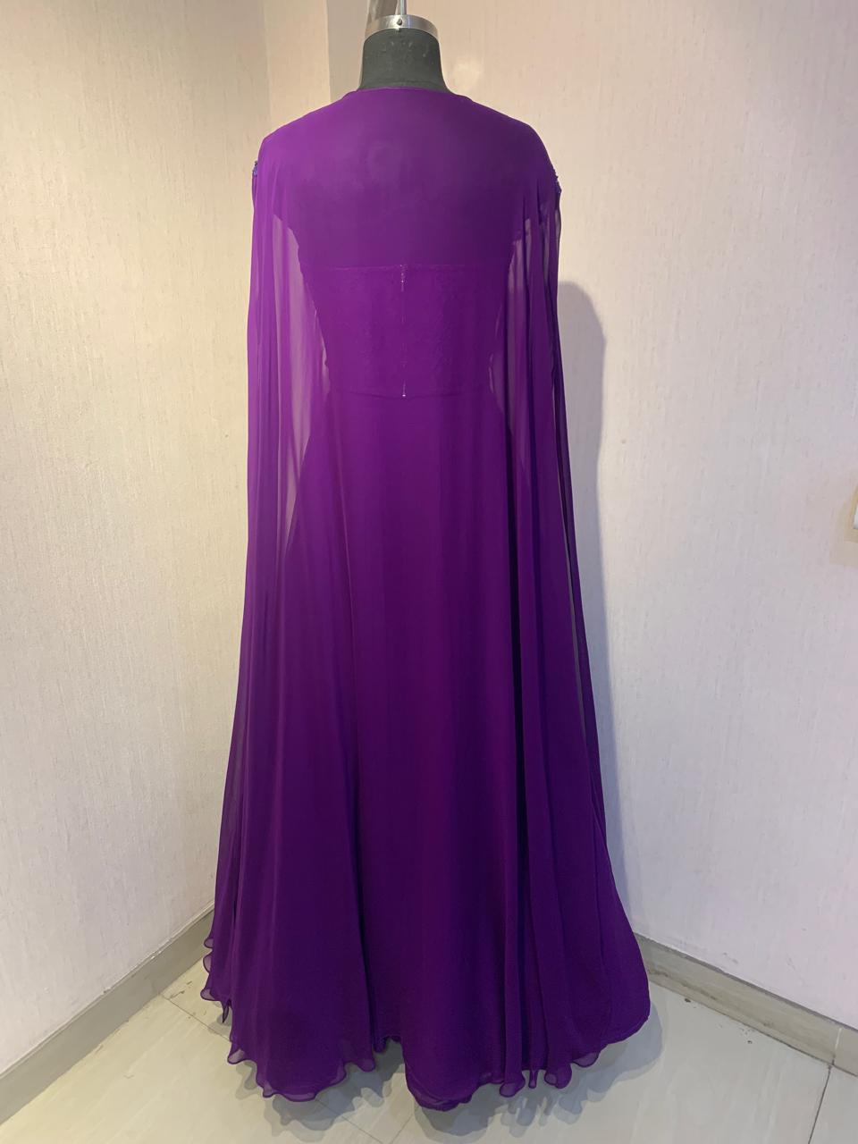 PURPLE EMBROIDERED CORSET TOP WITH FLARED SKIRT AND CAPE.