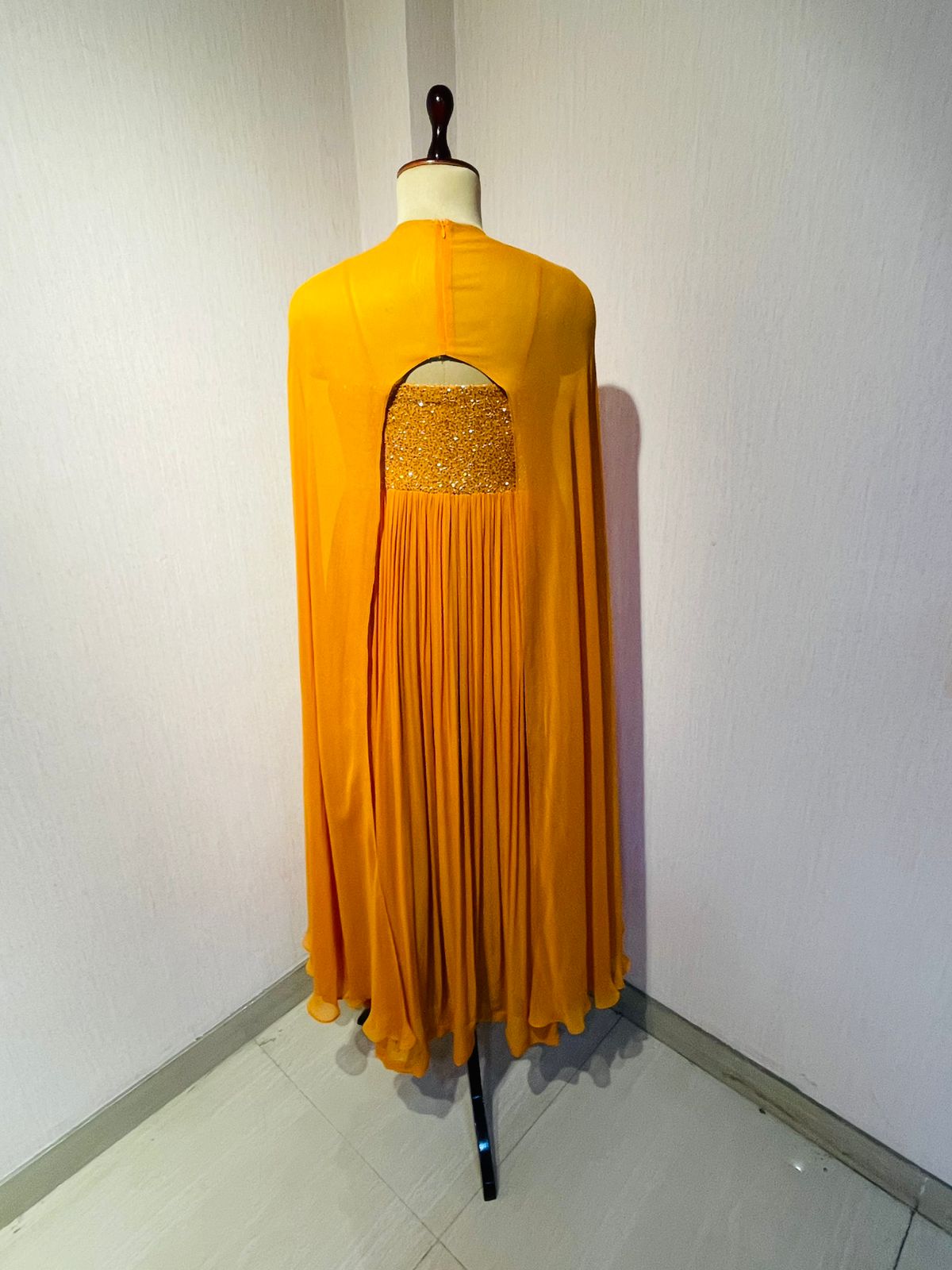 RUST EMBELLISHED CAPE STYLE PLEATED GOWN.