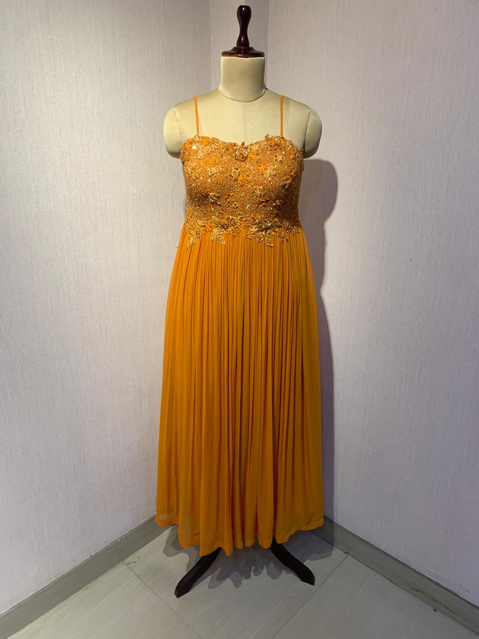 RUST EMBELLISHED CAPE STYLE PLEATED GOWN.