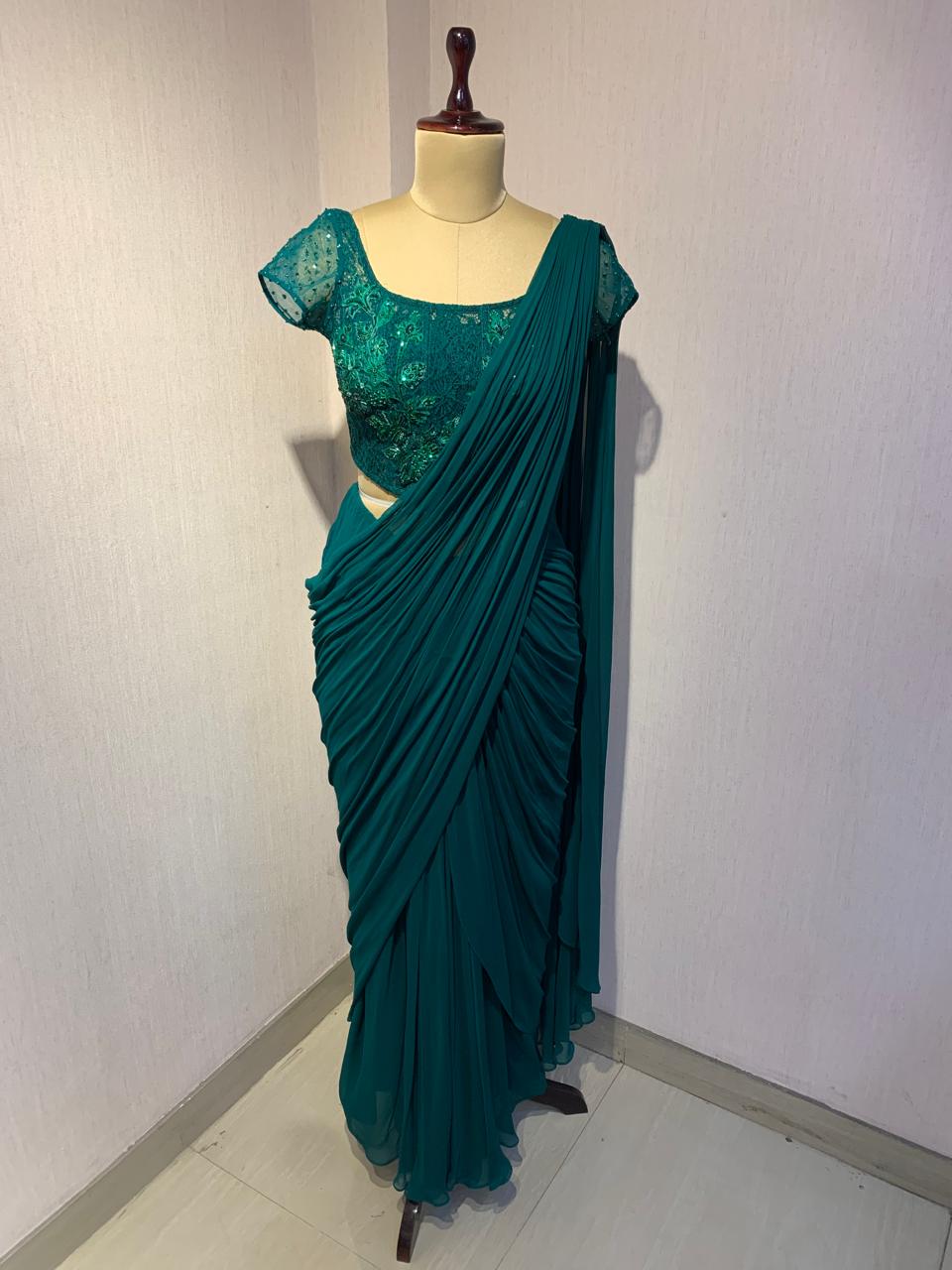 EMERALD GREEN EMBROIDERED DRAPED SAREE.
