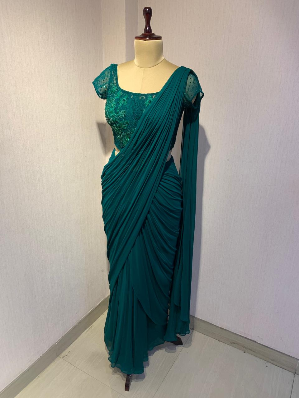 EMERALD GREEN EMBROIDERED DRAPED SAREE.